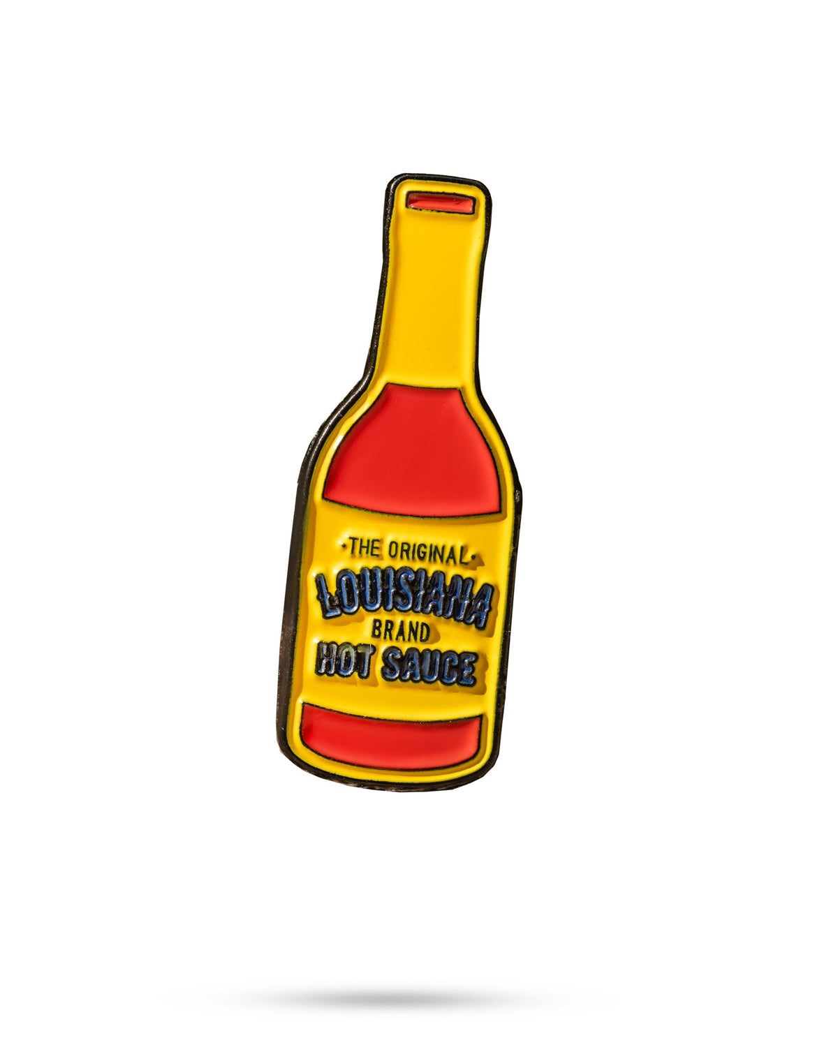 Bold Louisiana Hot Sauce ball marker featuring a colorful bottle design, perfect for adding flair to your golf game.
