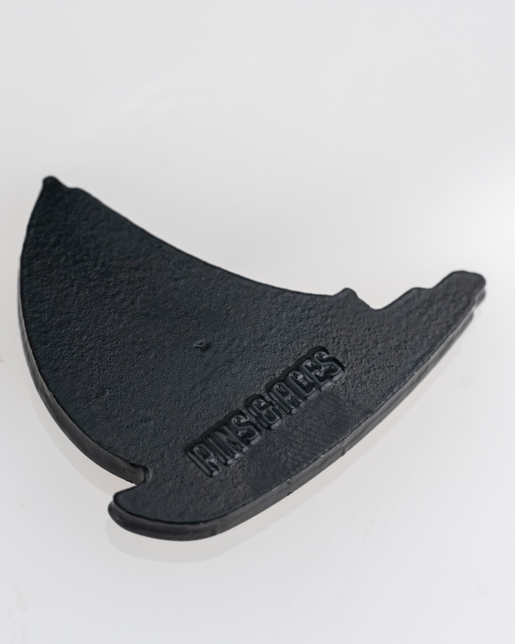 Sailboat-shaped black ball marker featuring the Pins and Aces logo, perfect for adding style to your golf game.