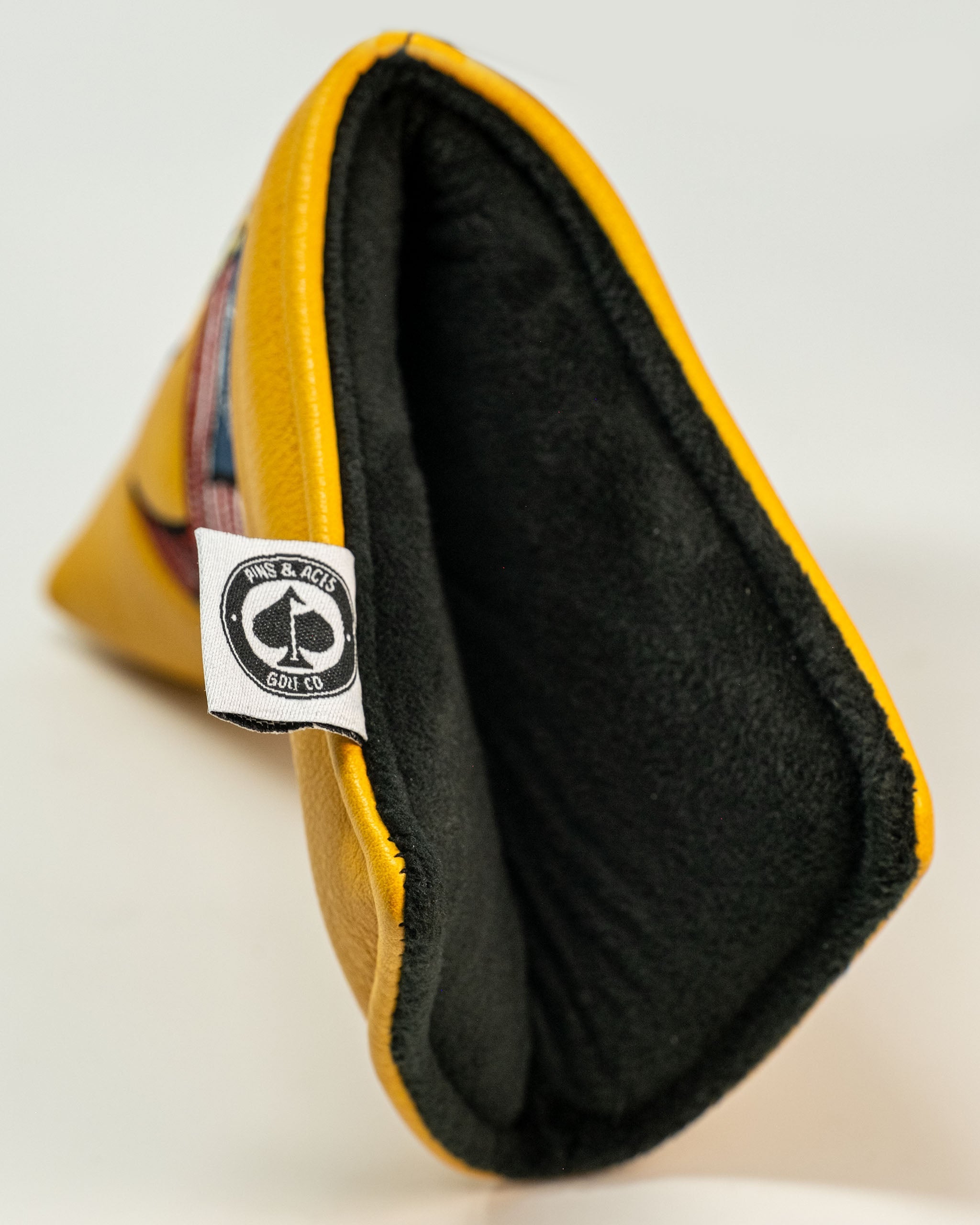 Yellow Patriot Blade Putter Cover with a soft black interior, designed for stylish protection on the golf course.