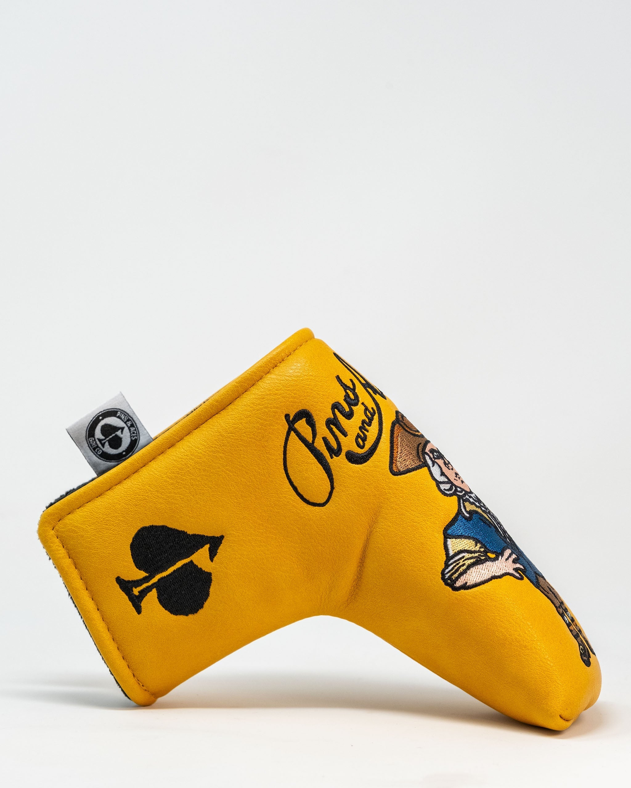 Bold yellow putter cover featuring a cowboy design and playful graphics, perfect for golfers who want to stand out.