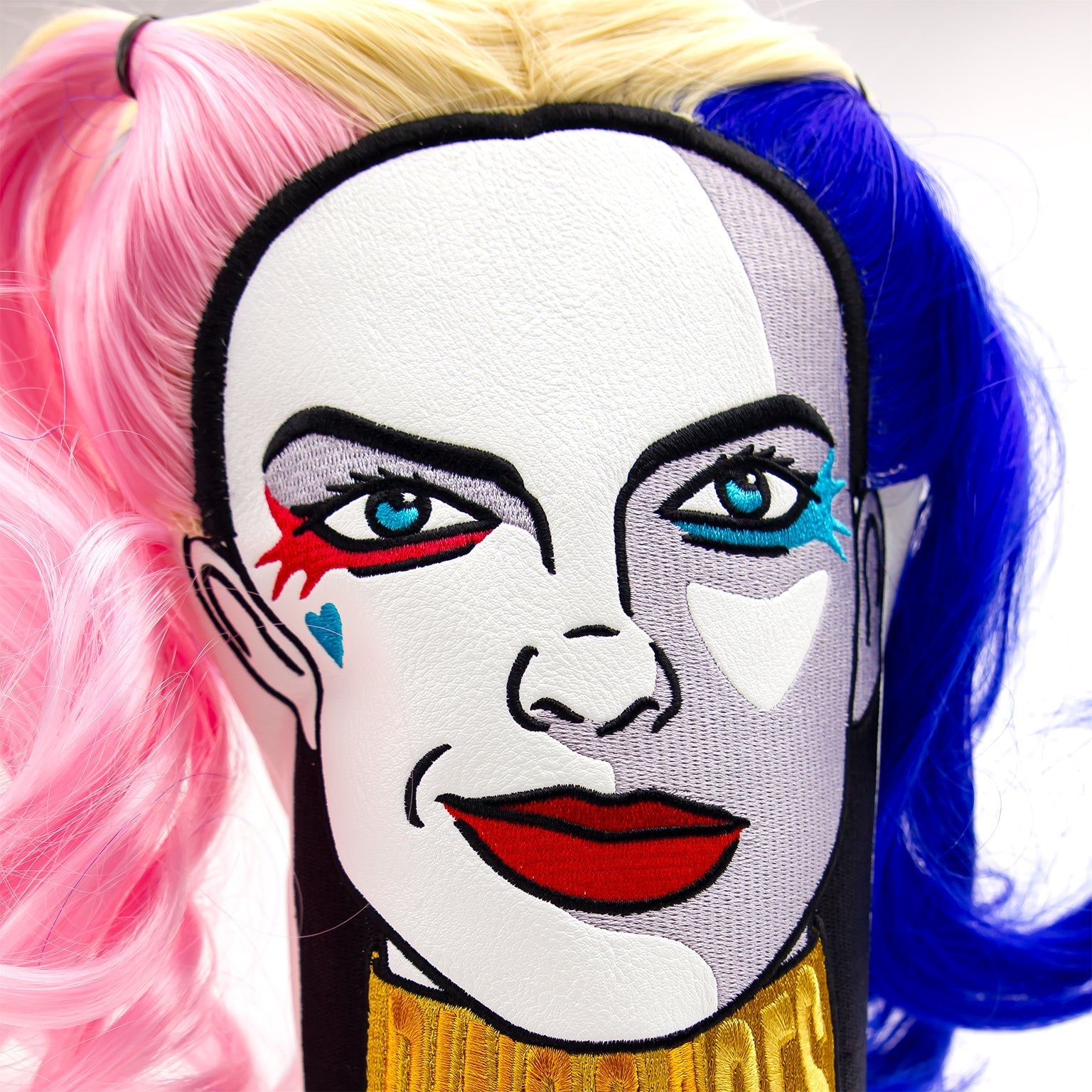 Bold driver cover featuring a stylized face design with vibrant hair colors, perfect for golfers wanting to stand out.