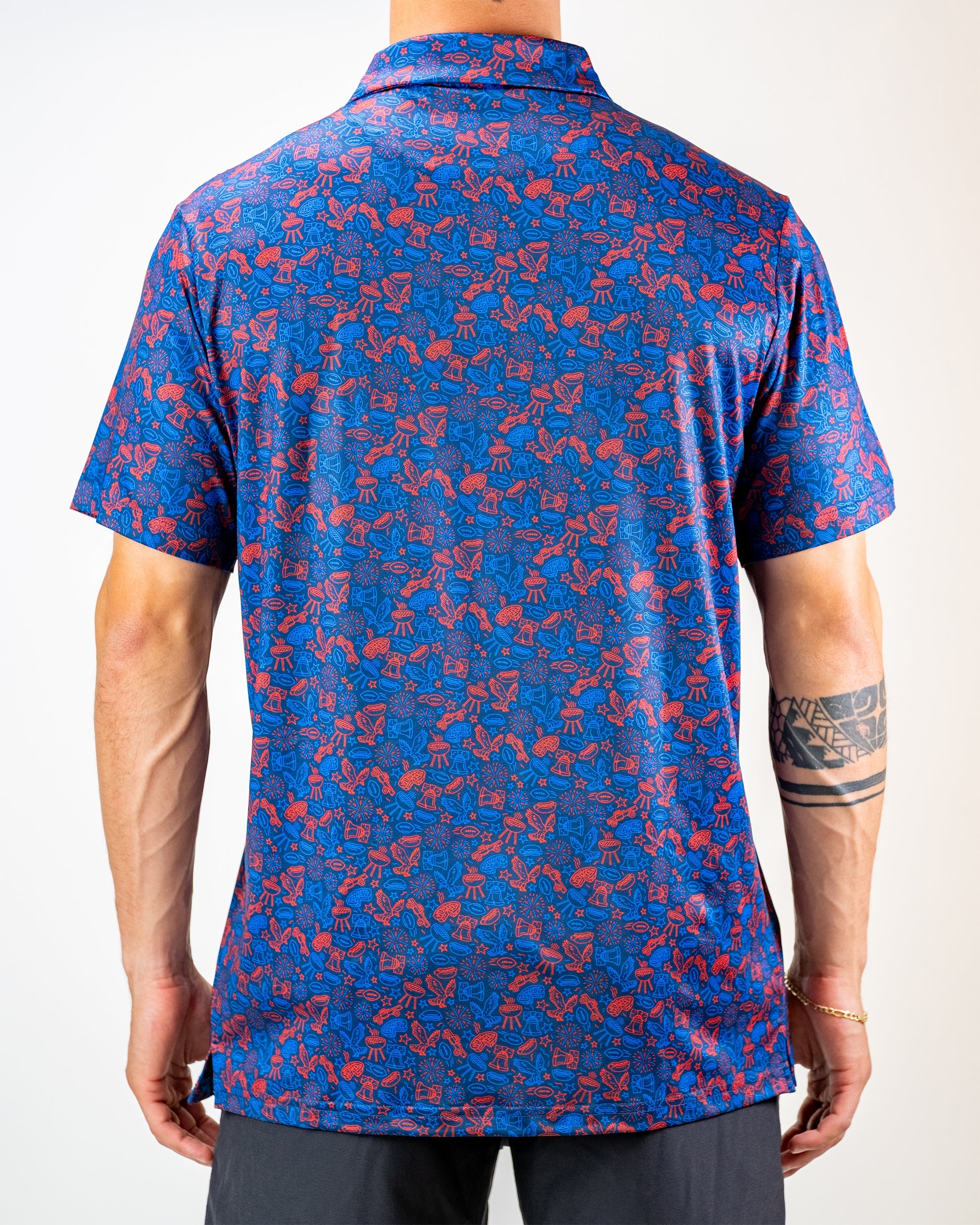 Navy golf shirt featuring a vibrant red doodle pattern, showcasing a unique and bold design on the back.