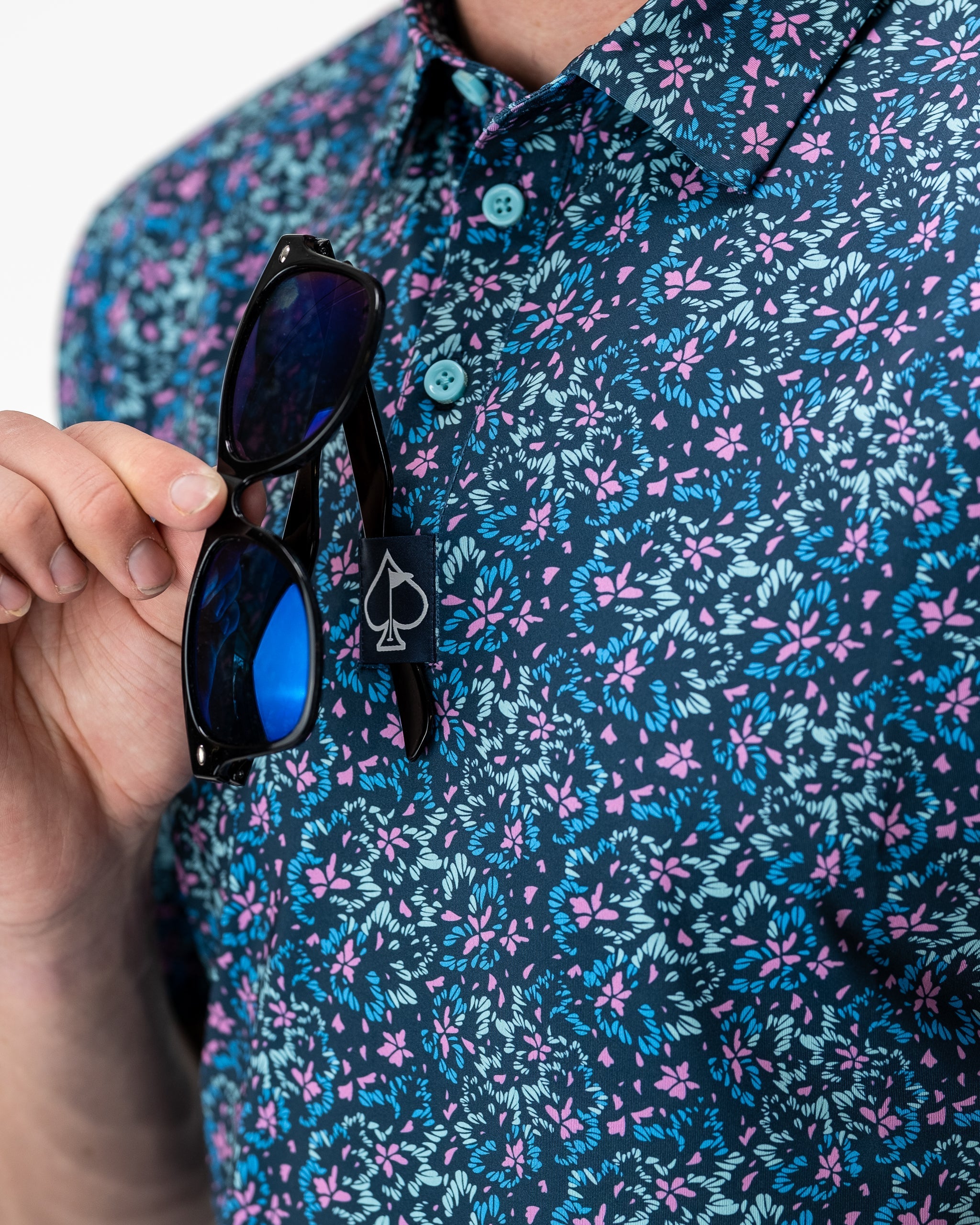 Fluorescent floral print dress on a model, showcasing vibrant colors and a spring-inspired design.