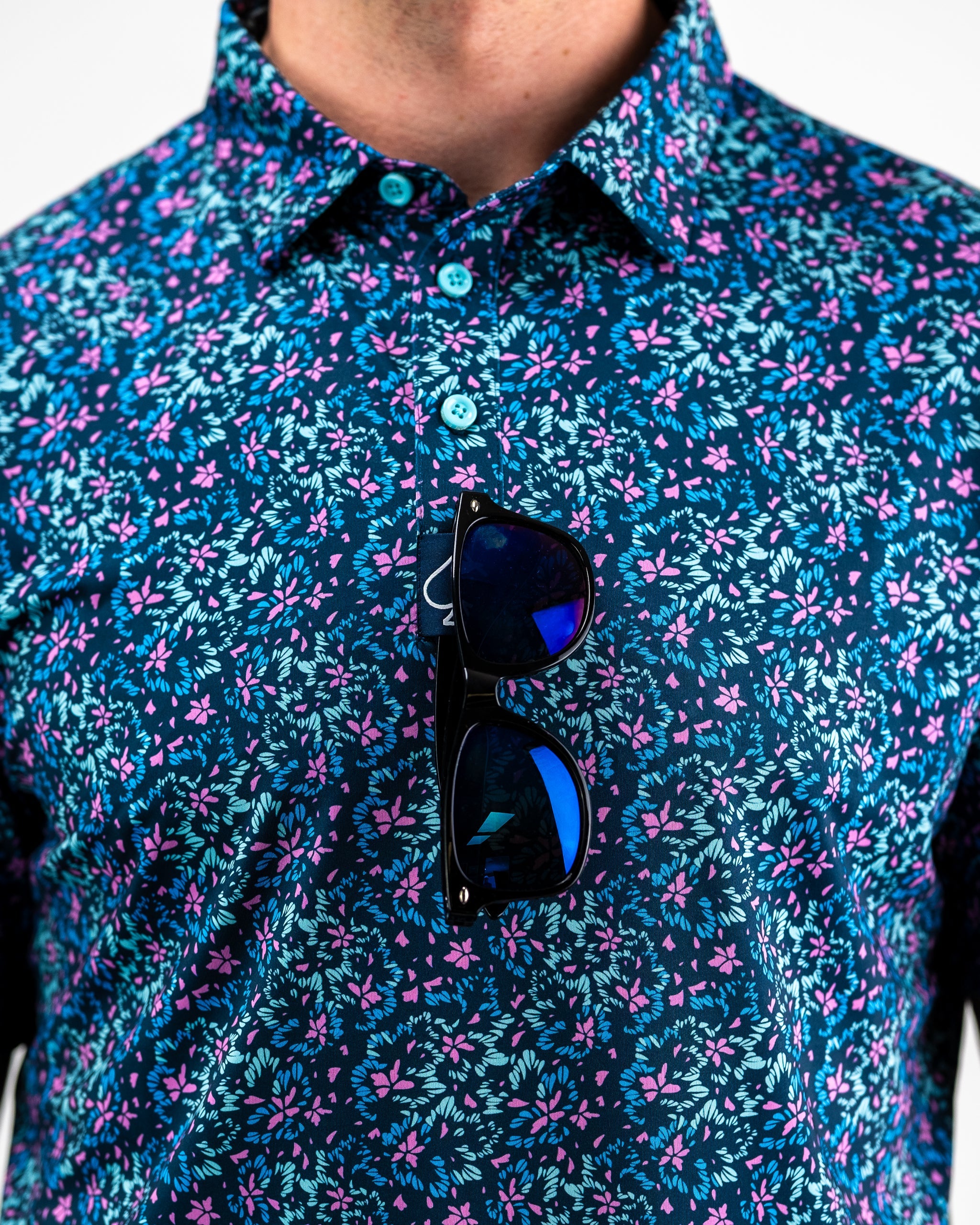 Brightly colored fluorescent floral dress with a vibrant pattern on a model, showcasing a spring/summer style.