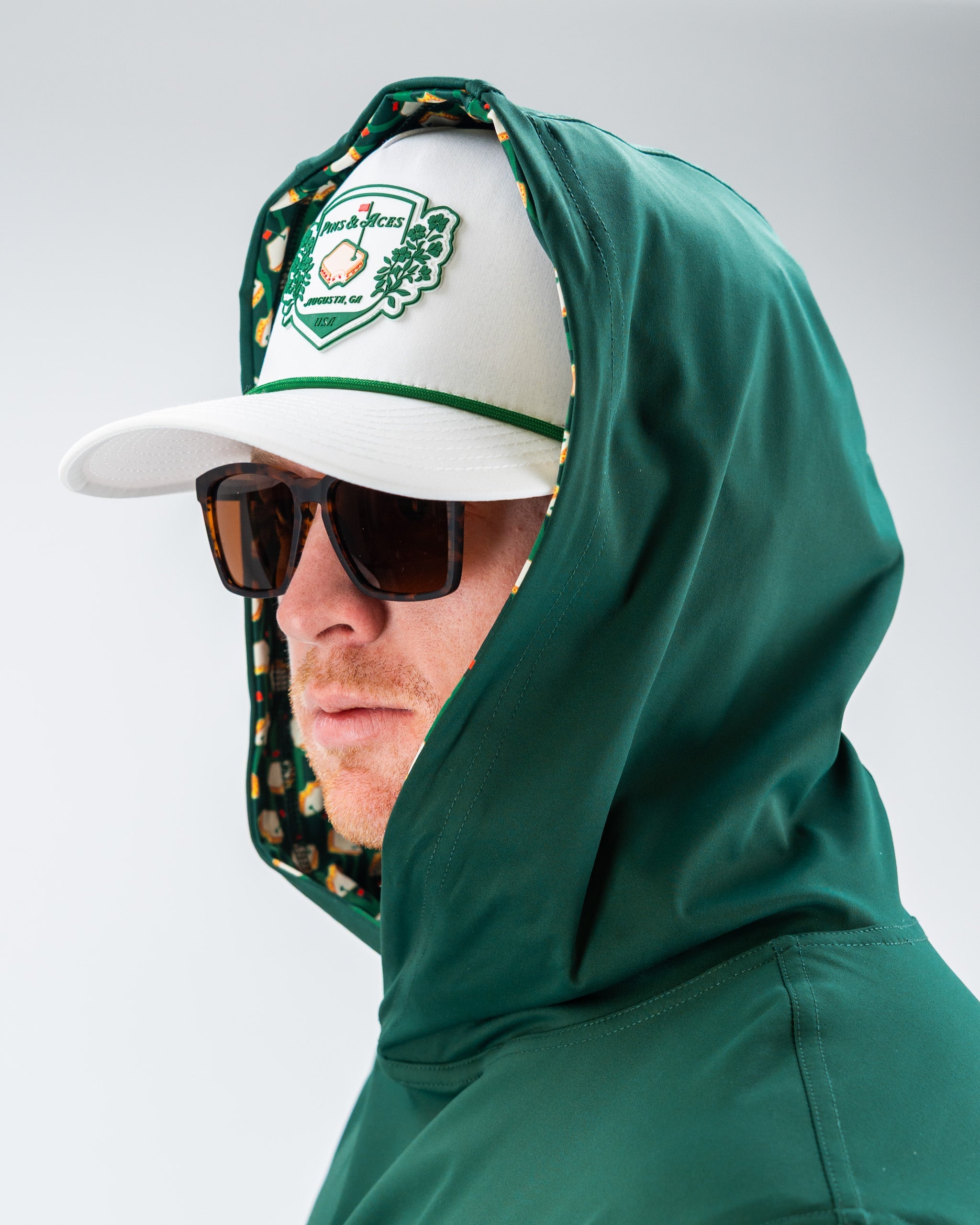 Performance Golf Hoodie in Pimento 4.0, featuring a sleek design with a hood and front pocket, ideal for on-course wear.