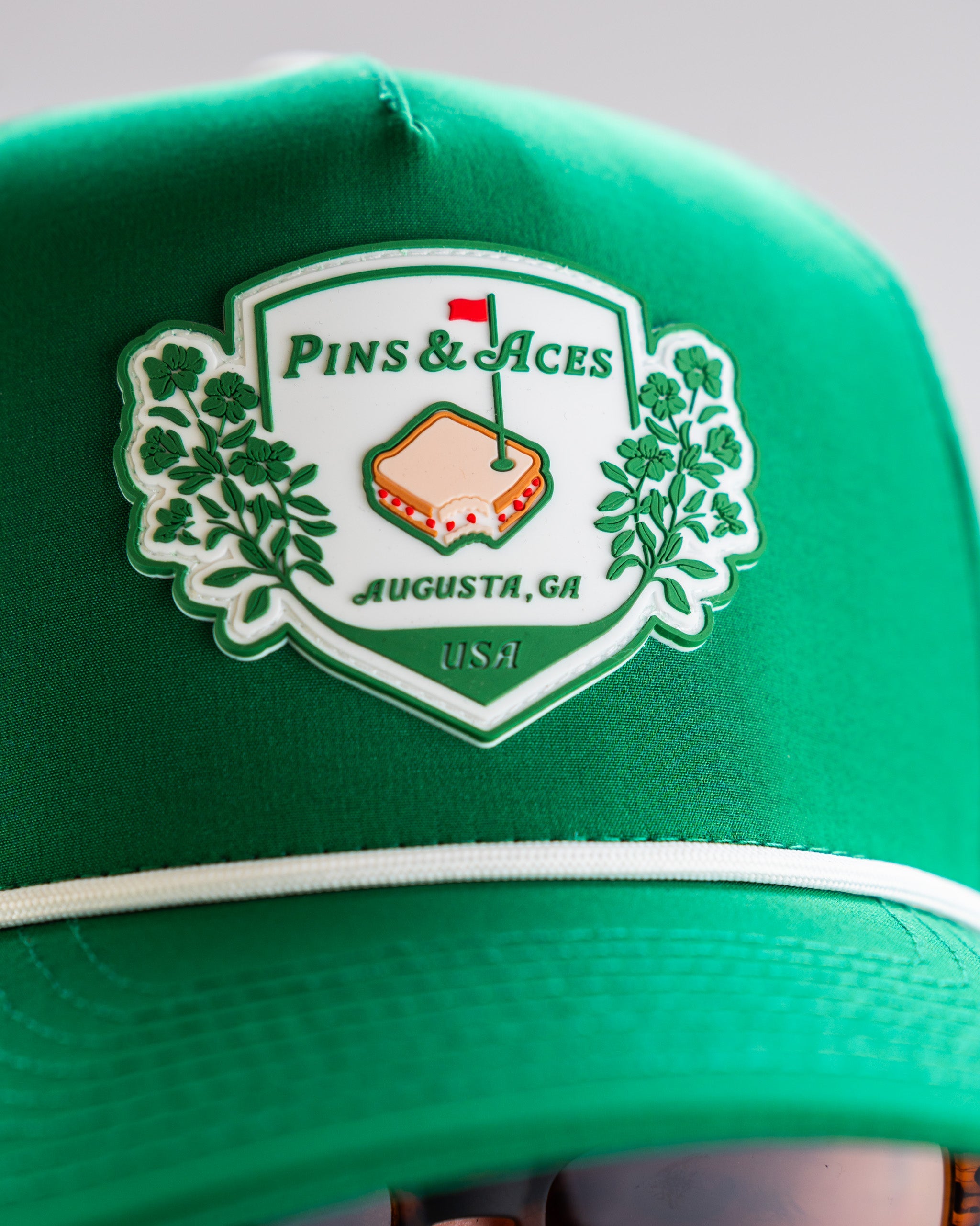 Green perforated rope hat by Pimento Crest, featuring a stylish design and adjustable fit.