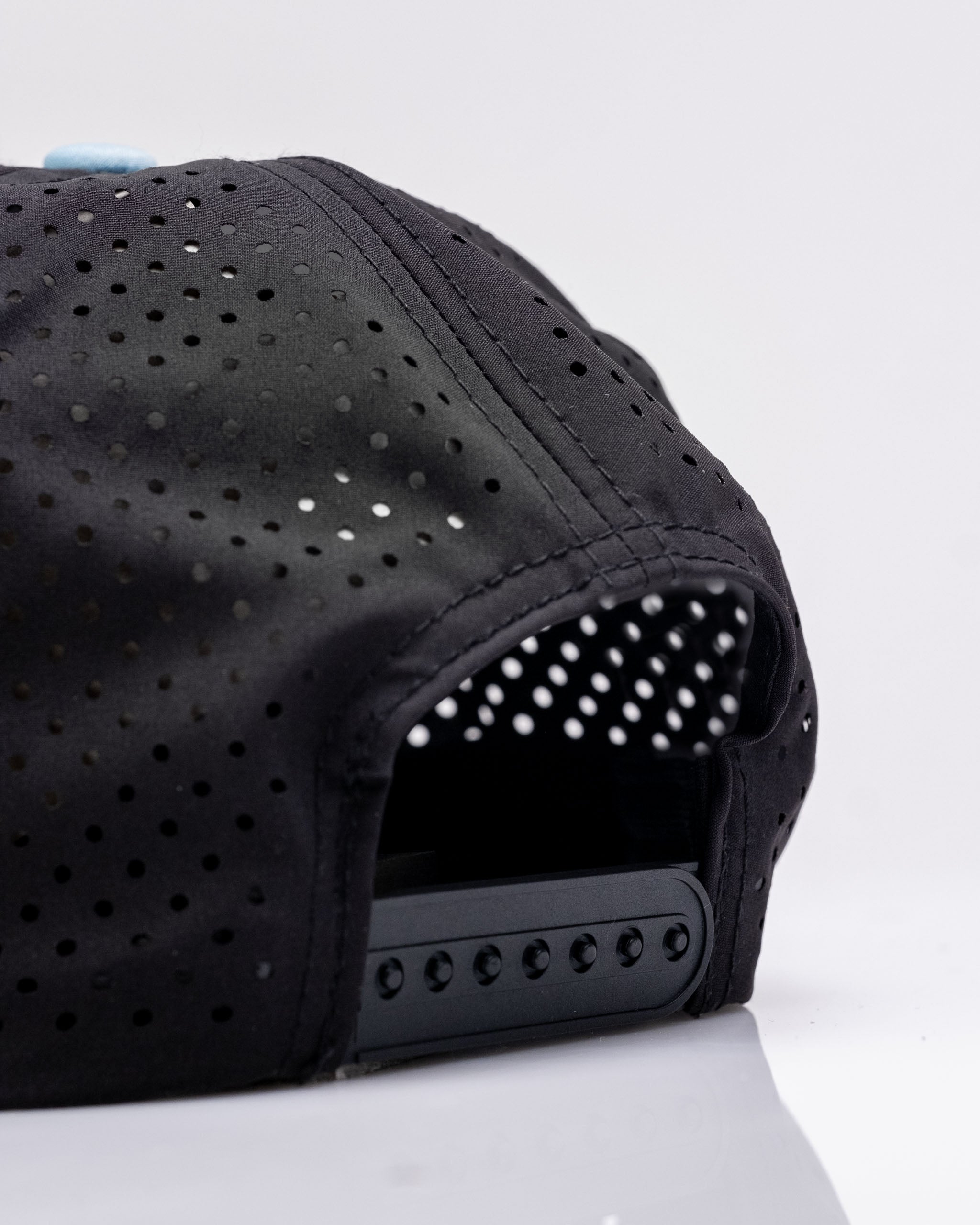 Perforated black rope hat featuring a stylish design, ideal for golfers seeking bold and unique headwear.