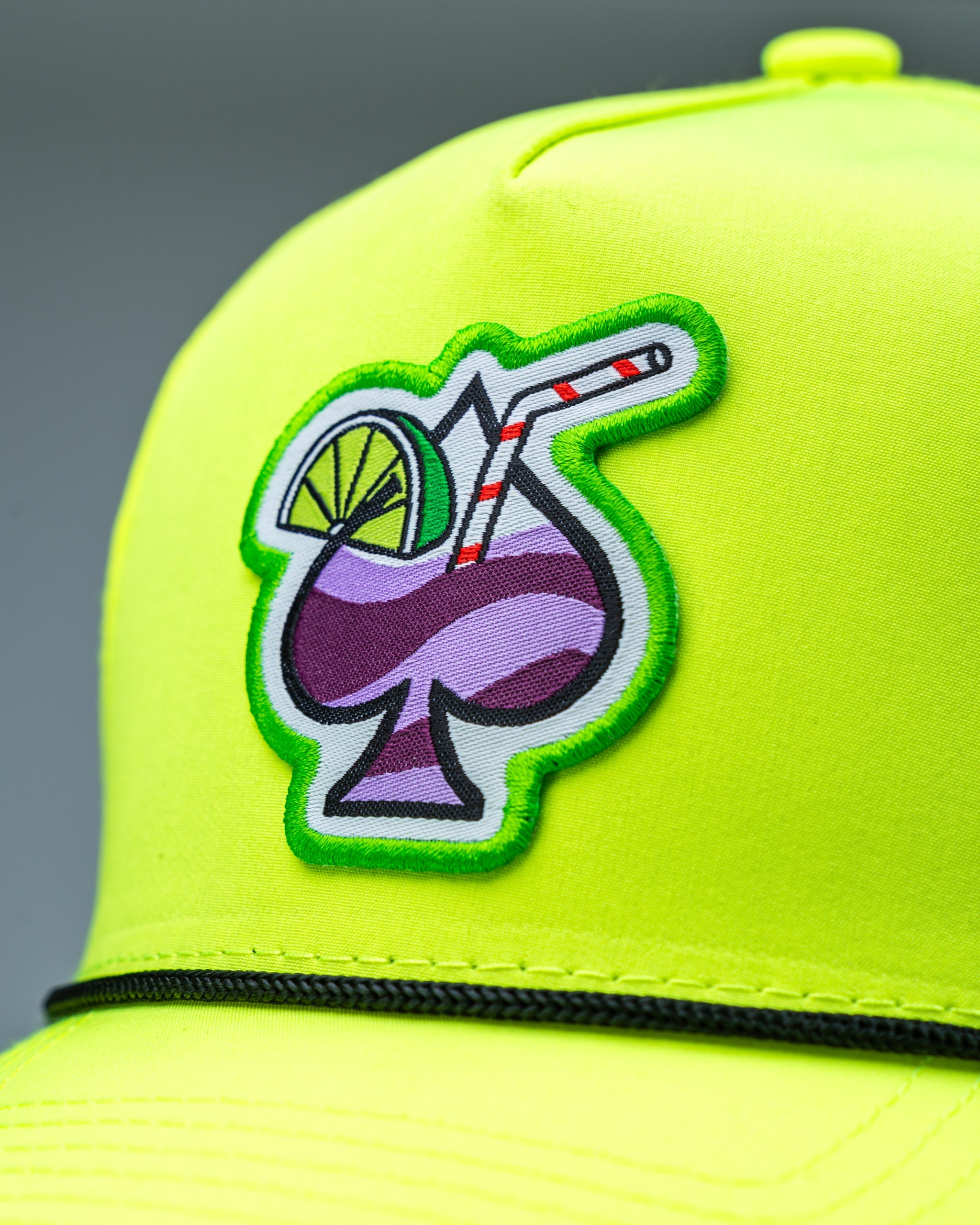Perforated rope hat in highlighter yellow with contrast detailing.