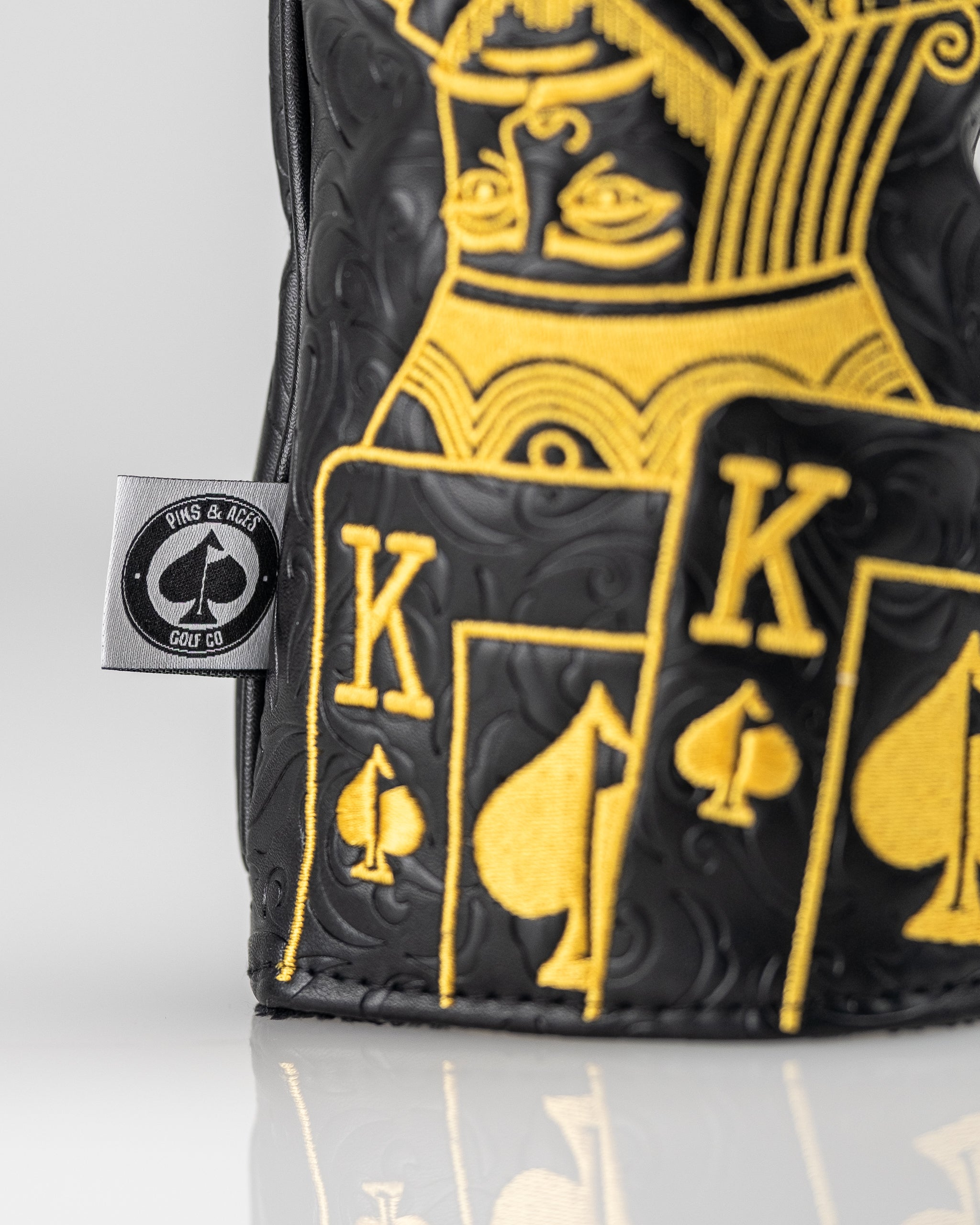 Black and gold King of Spades driver cover for golf clubs, featuring a stylish design and a snug fit.