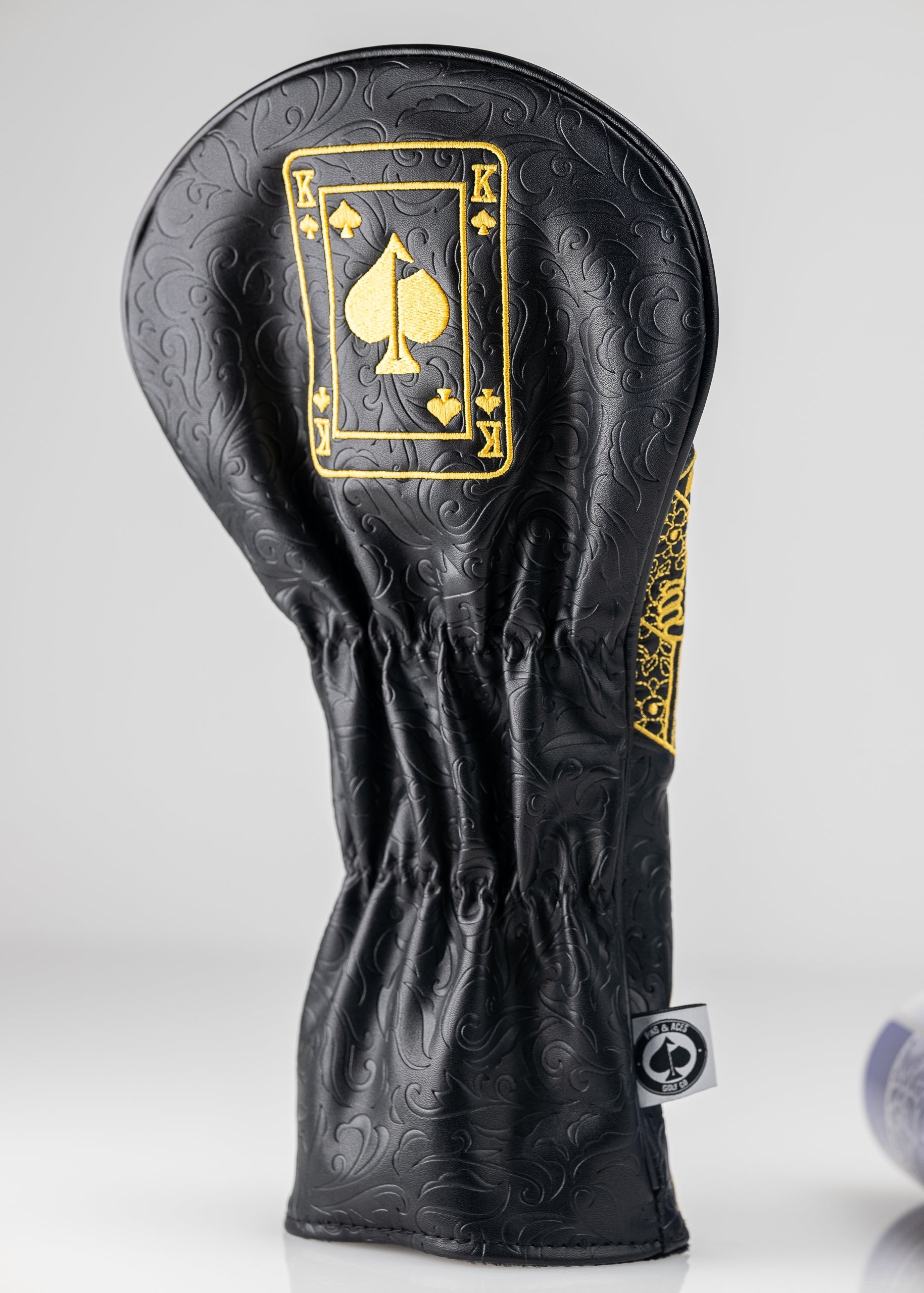 Black and gold King of Spades driver cover with a sleek design for golf clubs.