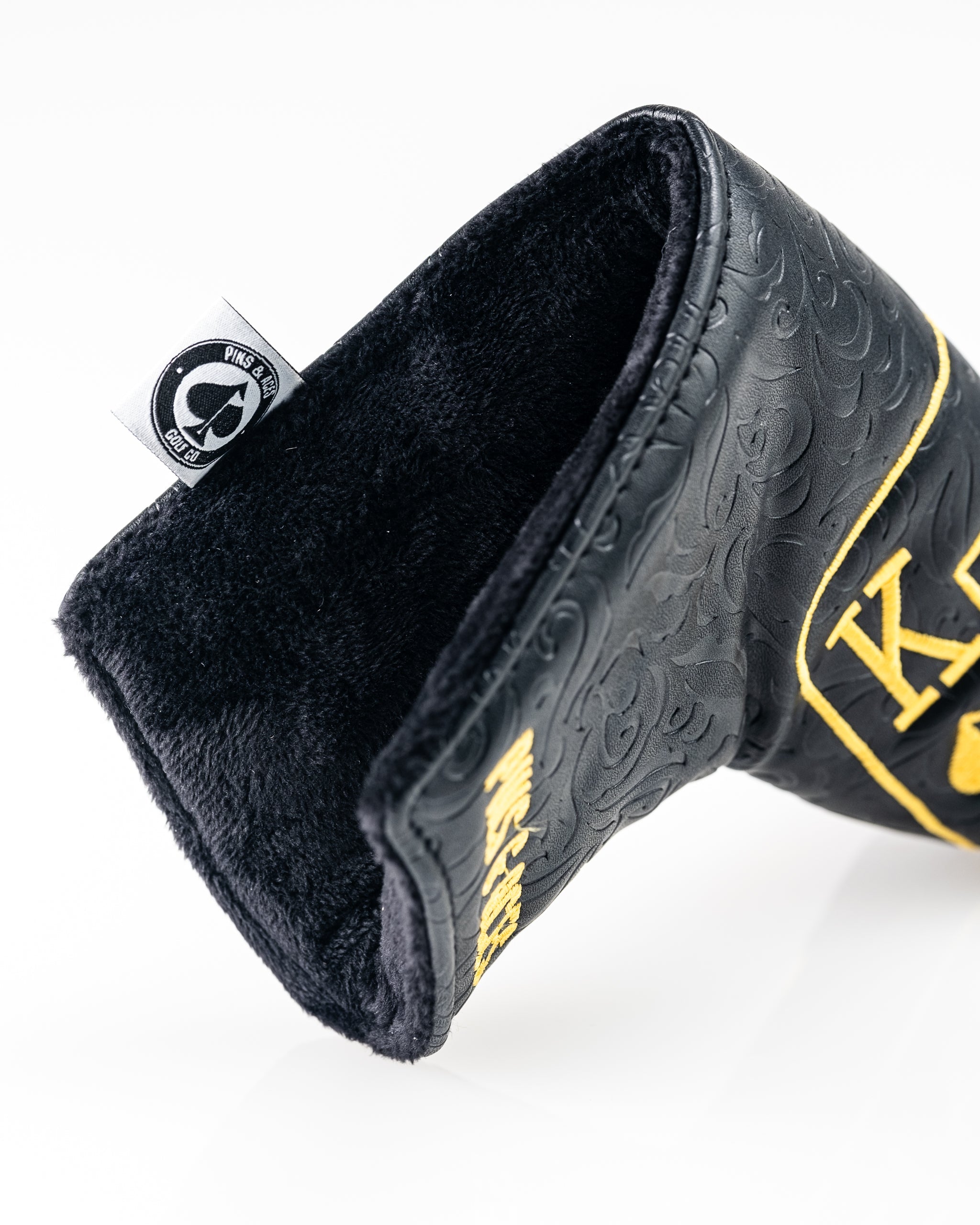 Black and gold Ace of Spades blade putter cover with a sleek design for enhanced club protection.