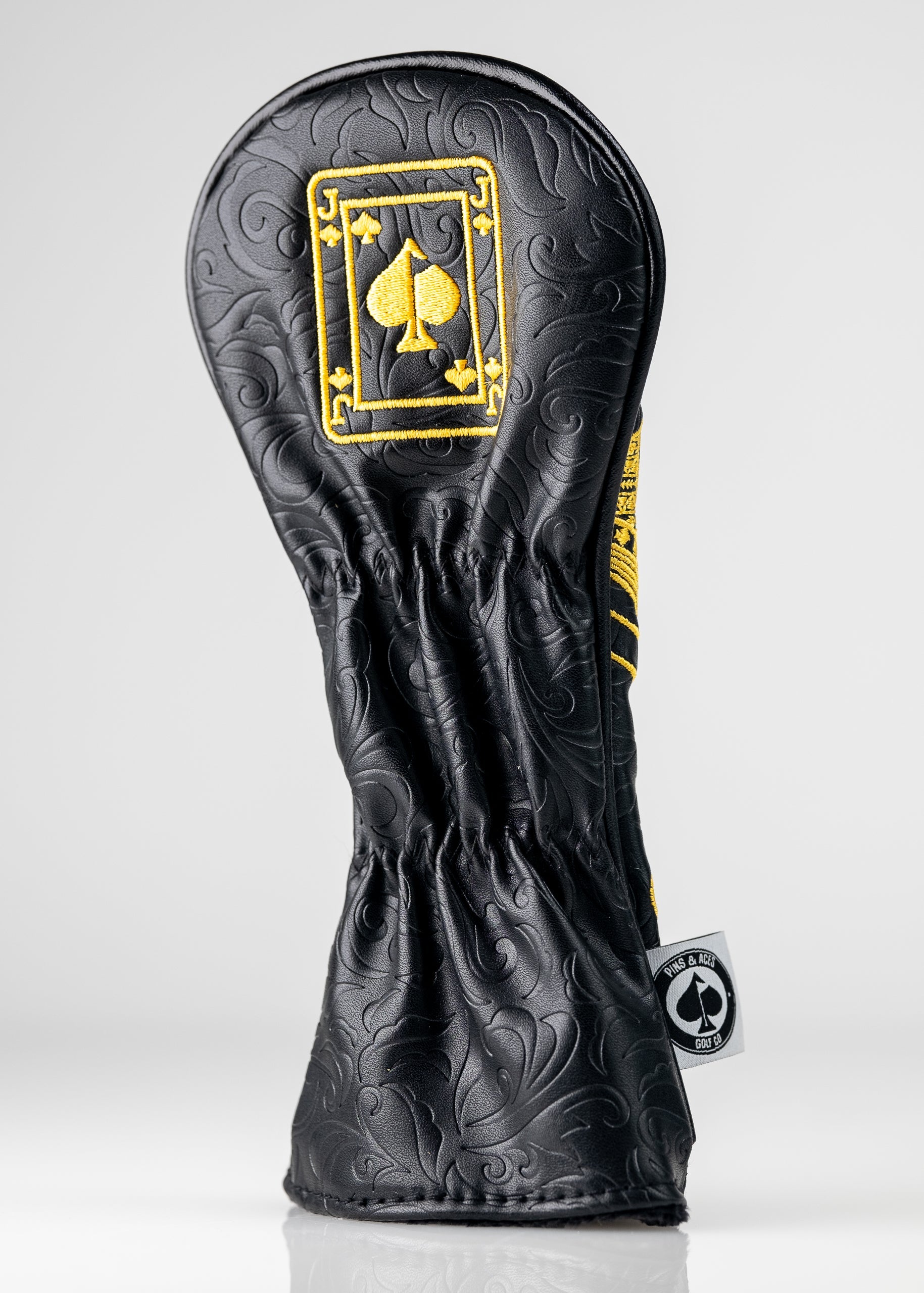 Black and gold Jack of Spades hybrid head cover with a sleek design and detailed embroidery.