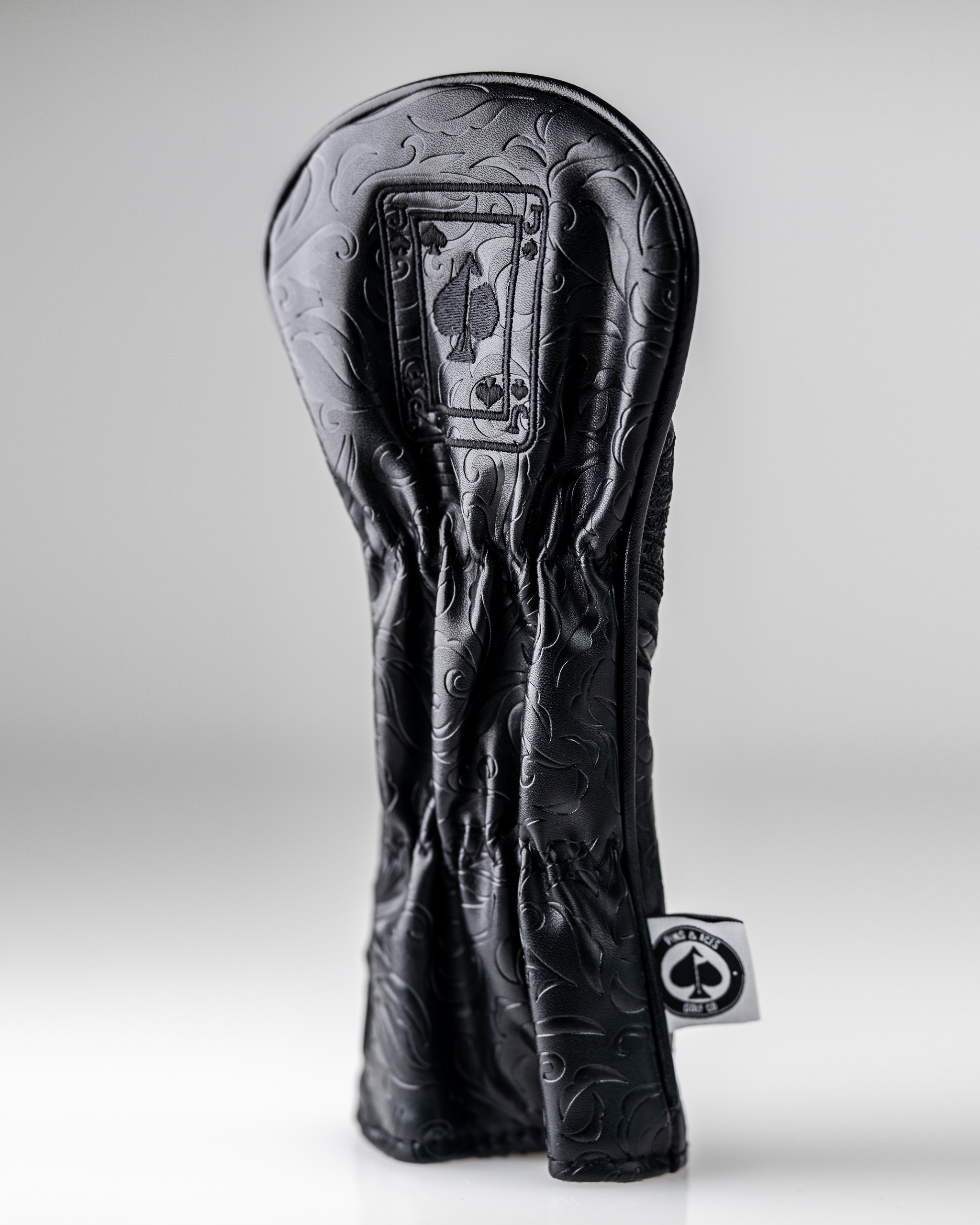 Blackout Jack of Spades hybrid golf club cover with embossed design, featuring a spade symbol and sleek black finish.