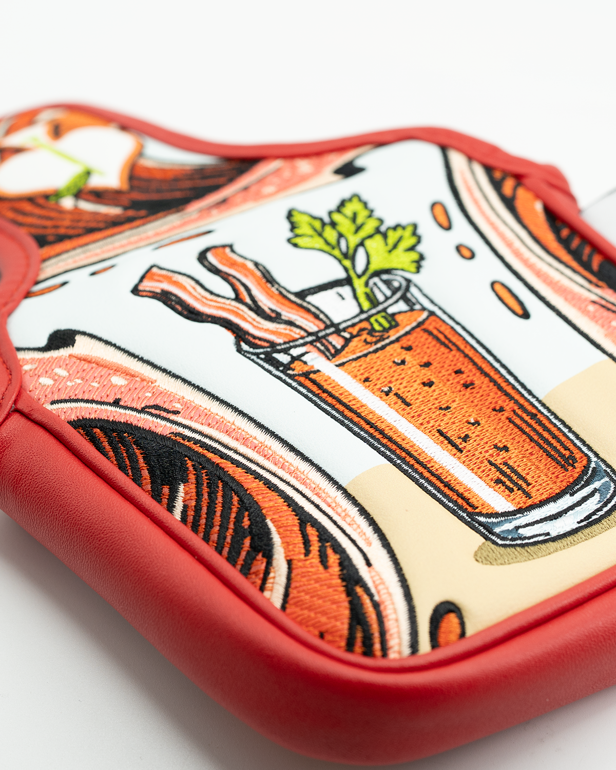 Bold Bloody Mary mallet putter cover featuring vibrant graphics of a cocktail with bacon and celery, perfect for stylish golfers.