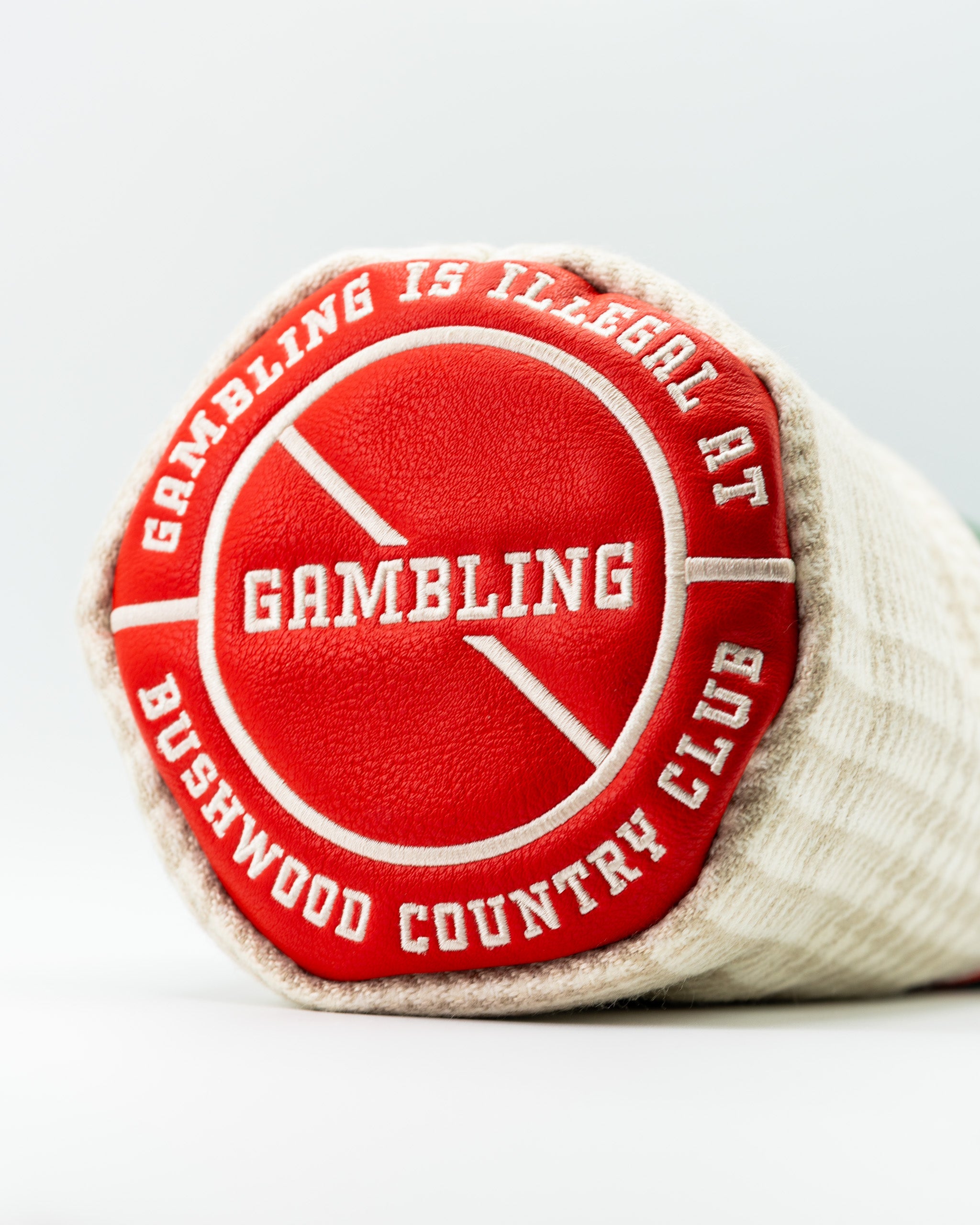 Bold driver cover featuring a red and white design with the text "Gambling is illegal at Bushwood Country Club.