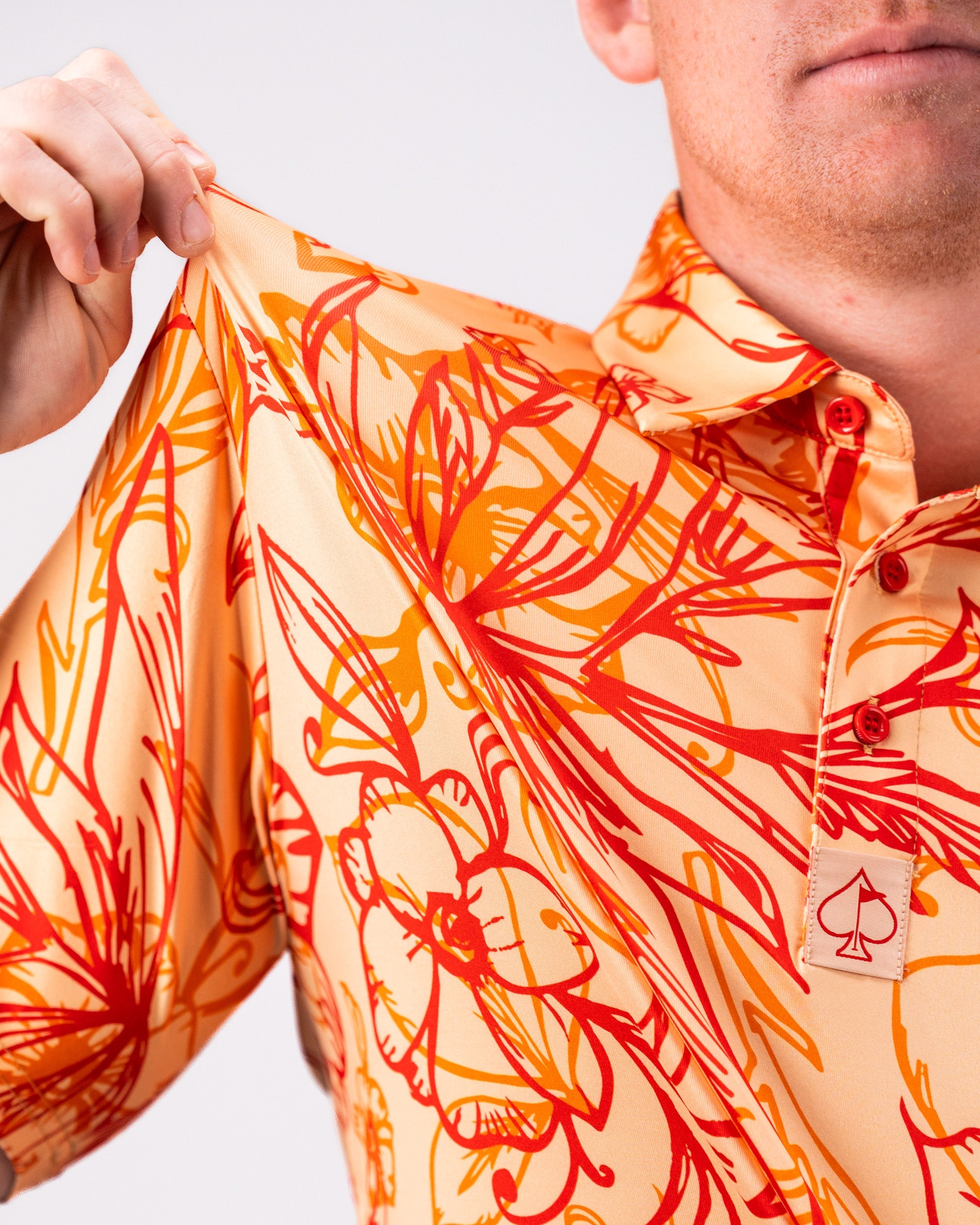 Cabo Sunburst polo shirt in vibrant sunset colors, showcasing a stylish design and breathable fabric.