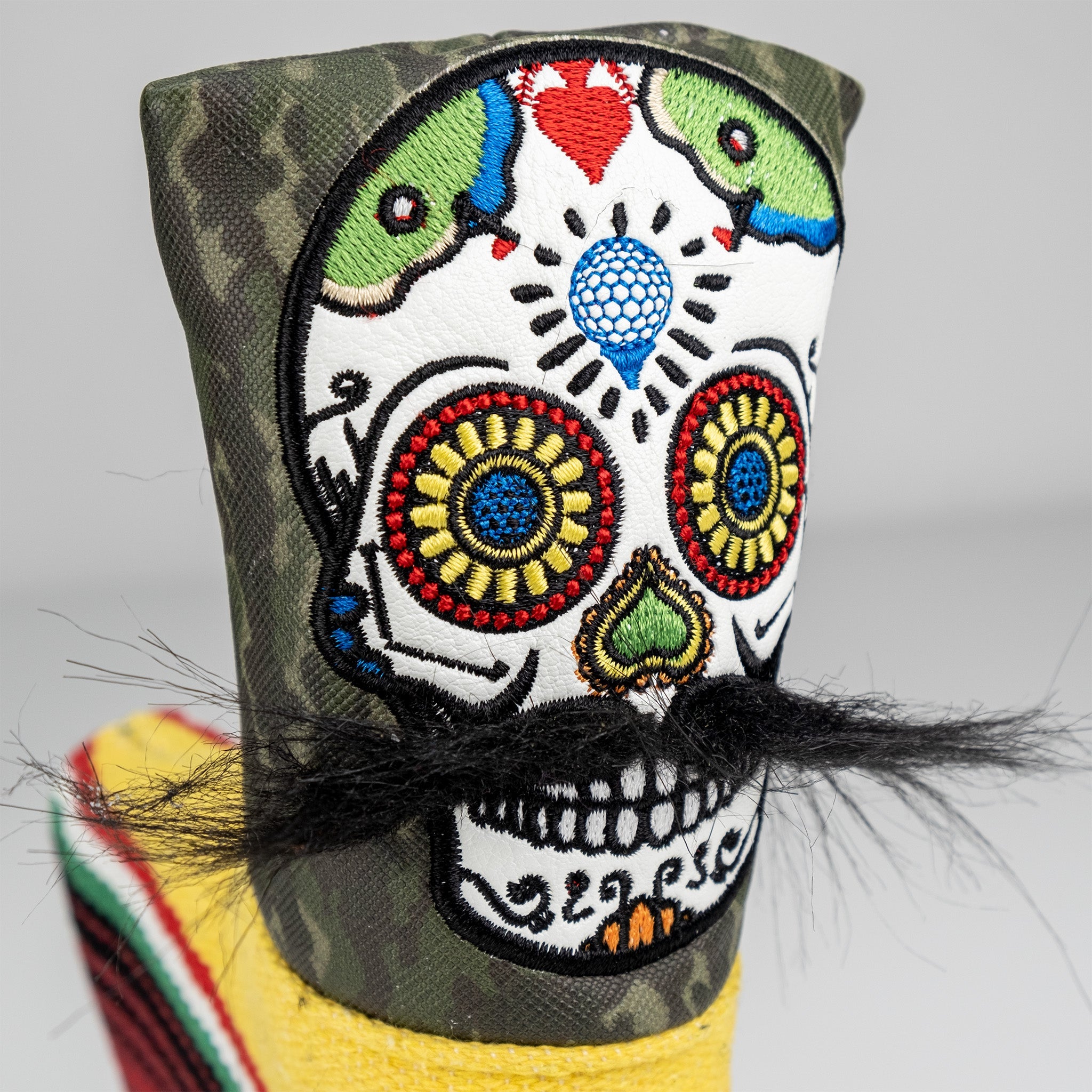 Mustache sugar skull design on a green camo Blade putter cover.