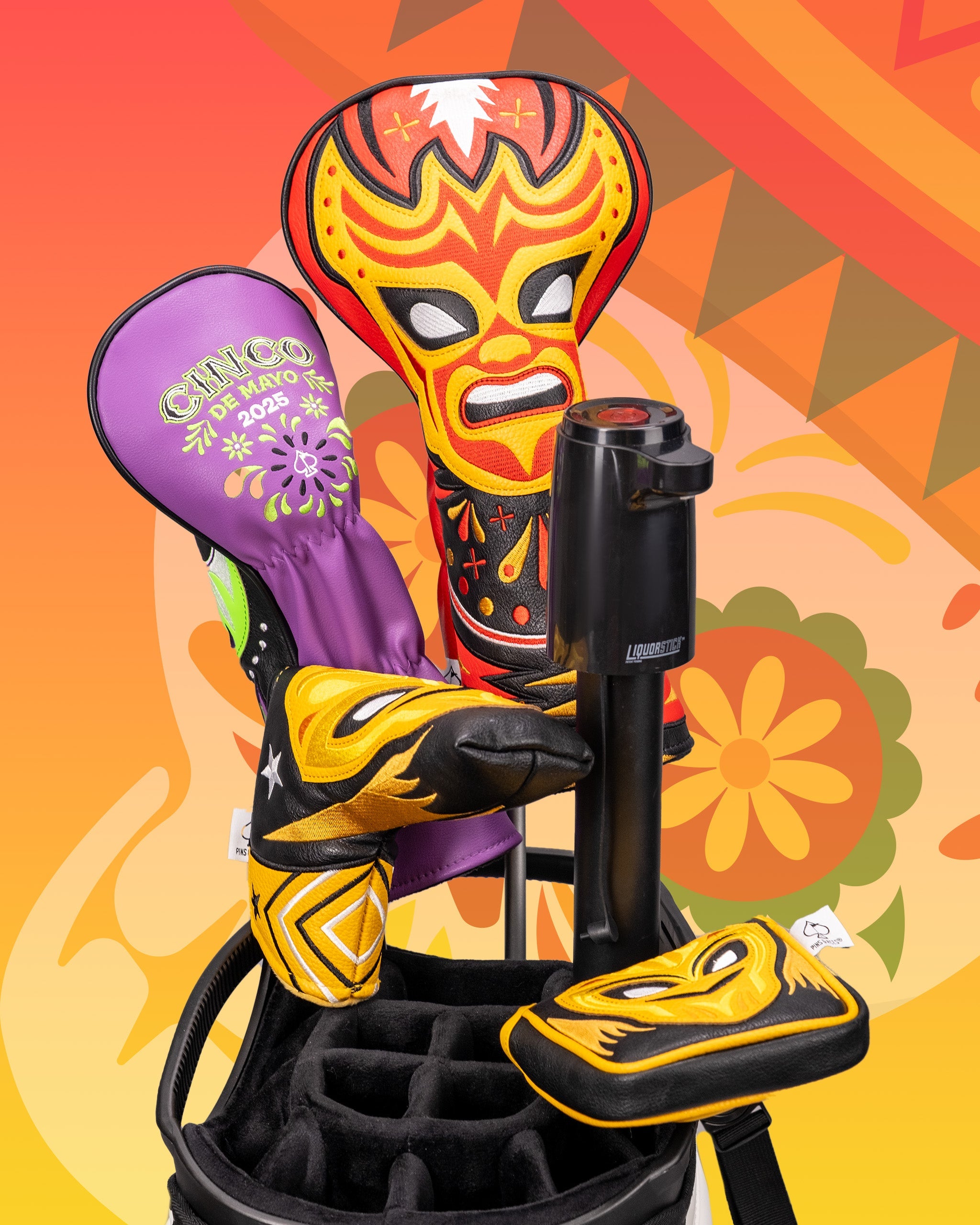Colorful lucha libre mask-themed golf driver cover with vibrant yellow, red, black, and purple design, displayed on a golf bag.