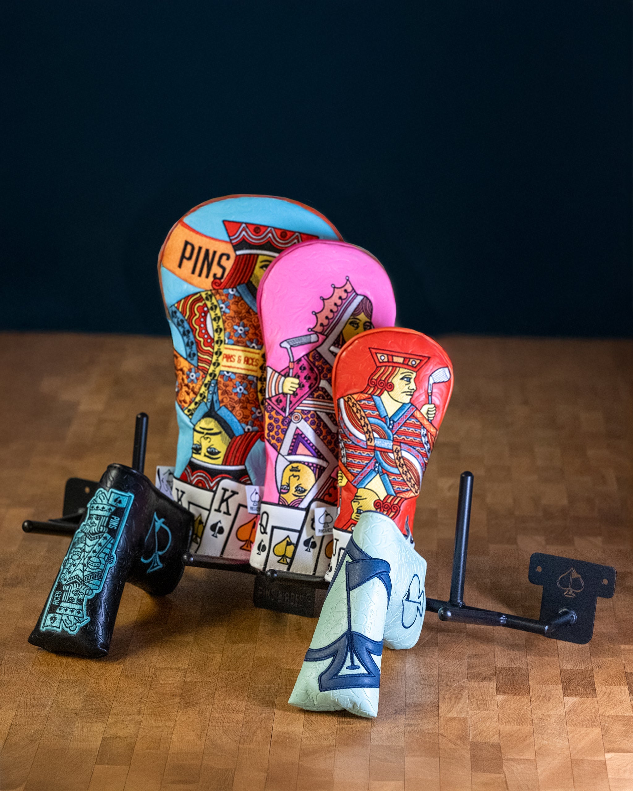 Compact Headcover Rack displayed on a wooden table, featuring a sleek design for organizing golf headcovers.