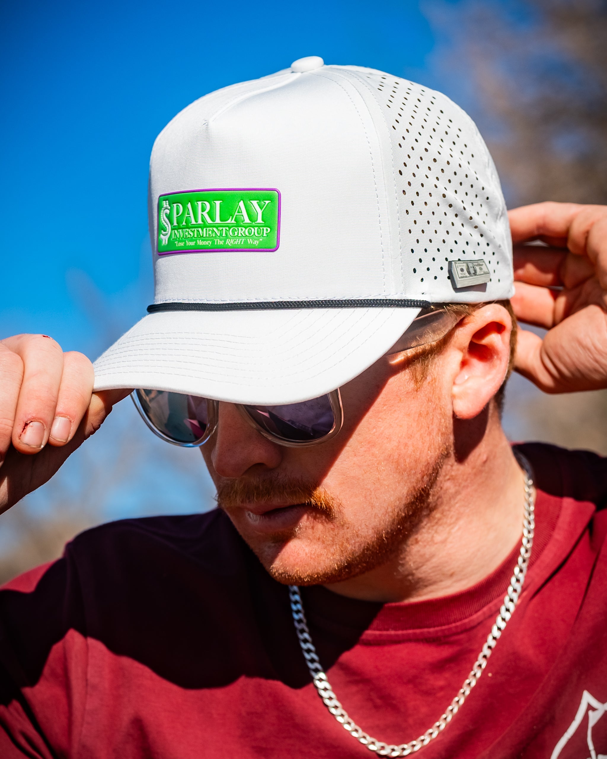 Perforated white rope hat featuring embroidered Parlay Investment Group logo.