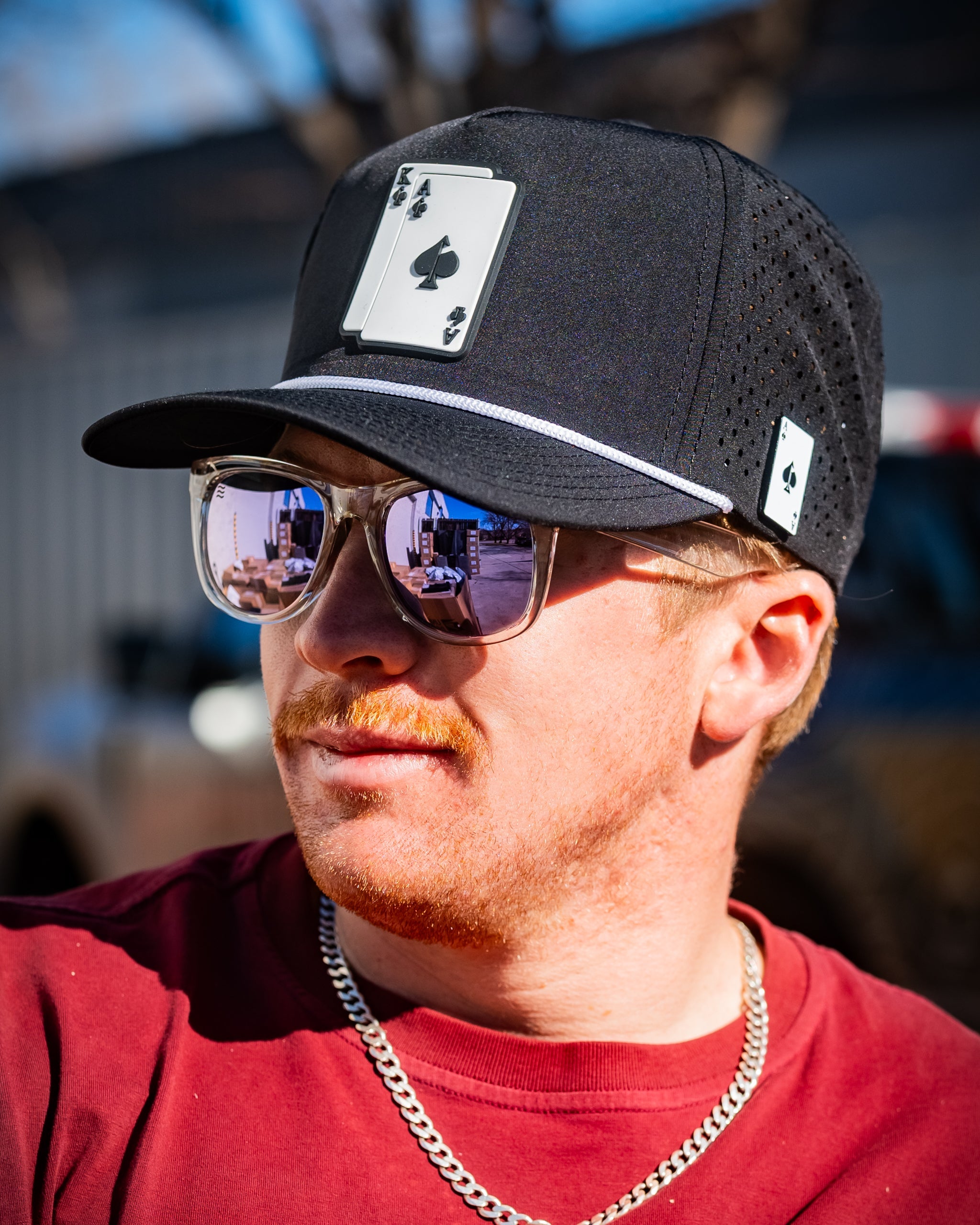 Black perforated rope hat with "AK" logo.