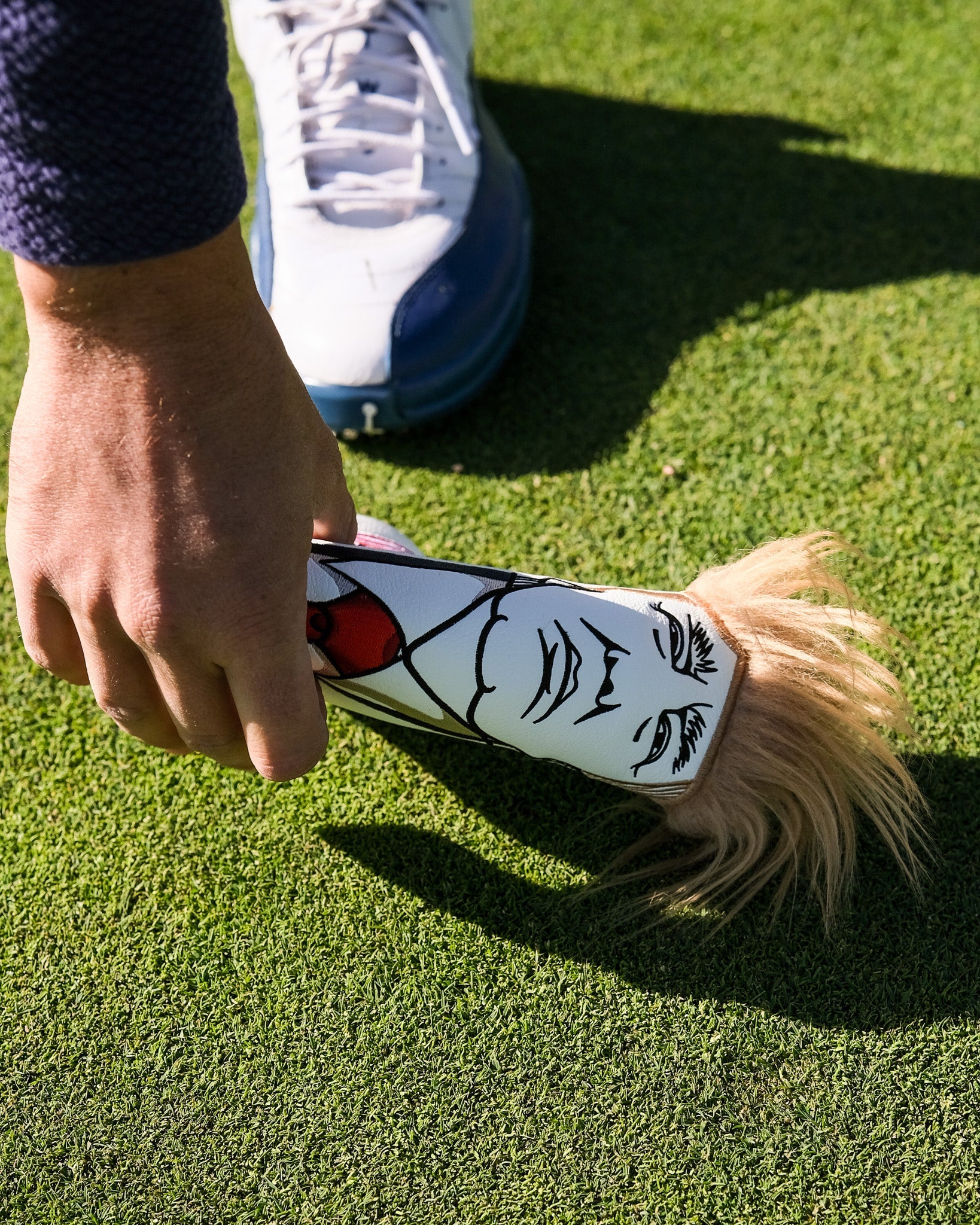 Trump Blade Putter Cover featuring a bold design with red, white, and blue colors and Trump branding, ideal for golfers looking to add a patriotic touch to their gear.