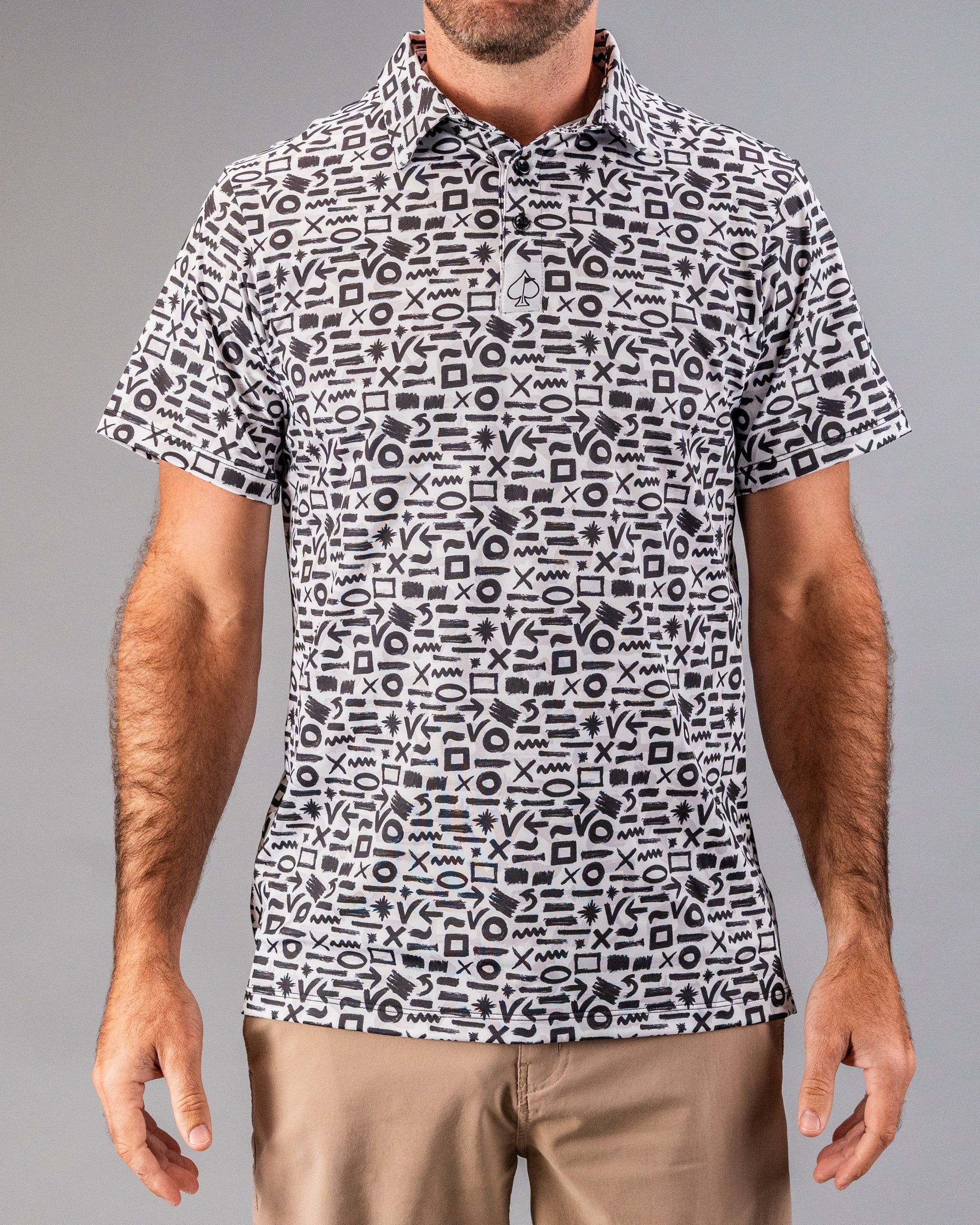 Black and white patterned golf polo with bold geometric symbols, perfect for golfers who want to stand out.
