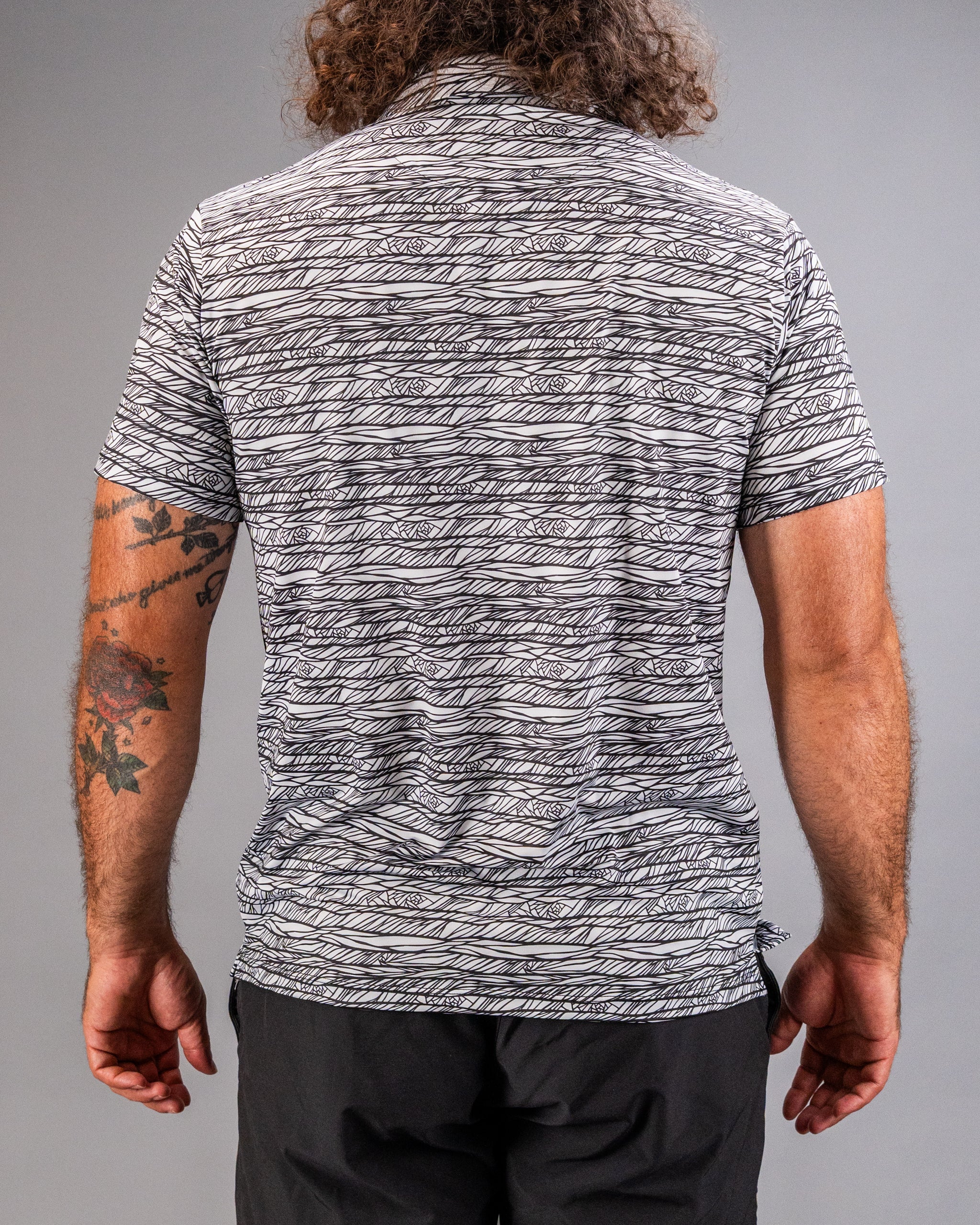 Men's Fragment Black golf shirt featuring a unique abstract pattern, designed for style and comfort on the course.