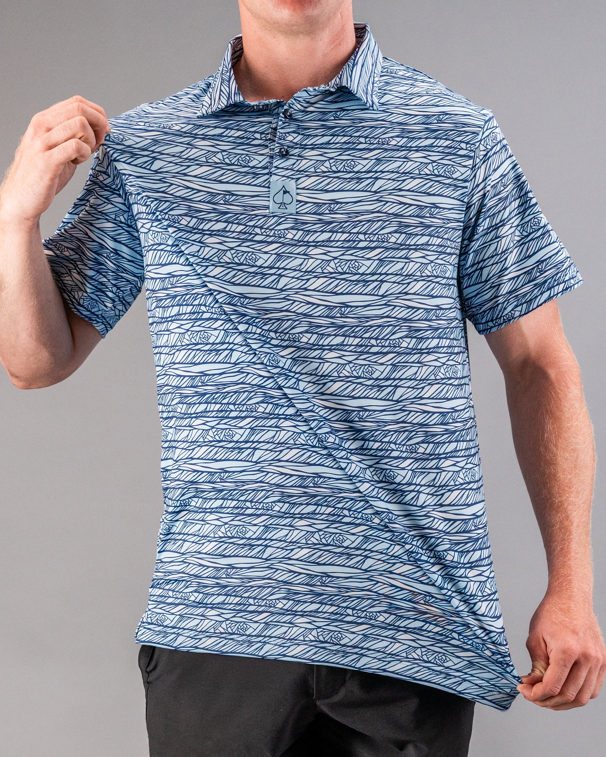 Bold blue and white patterned golf polo with a subtle spade logo, perfect for standing out on the course.
