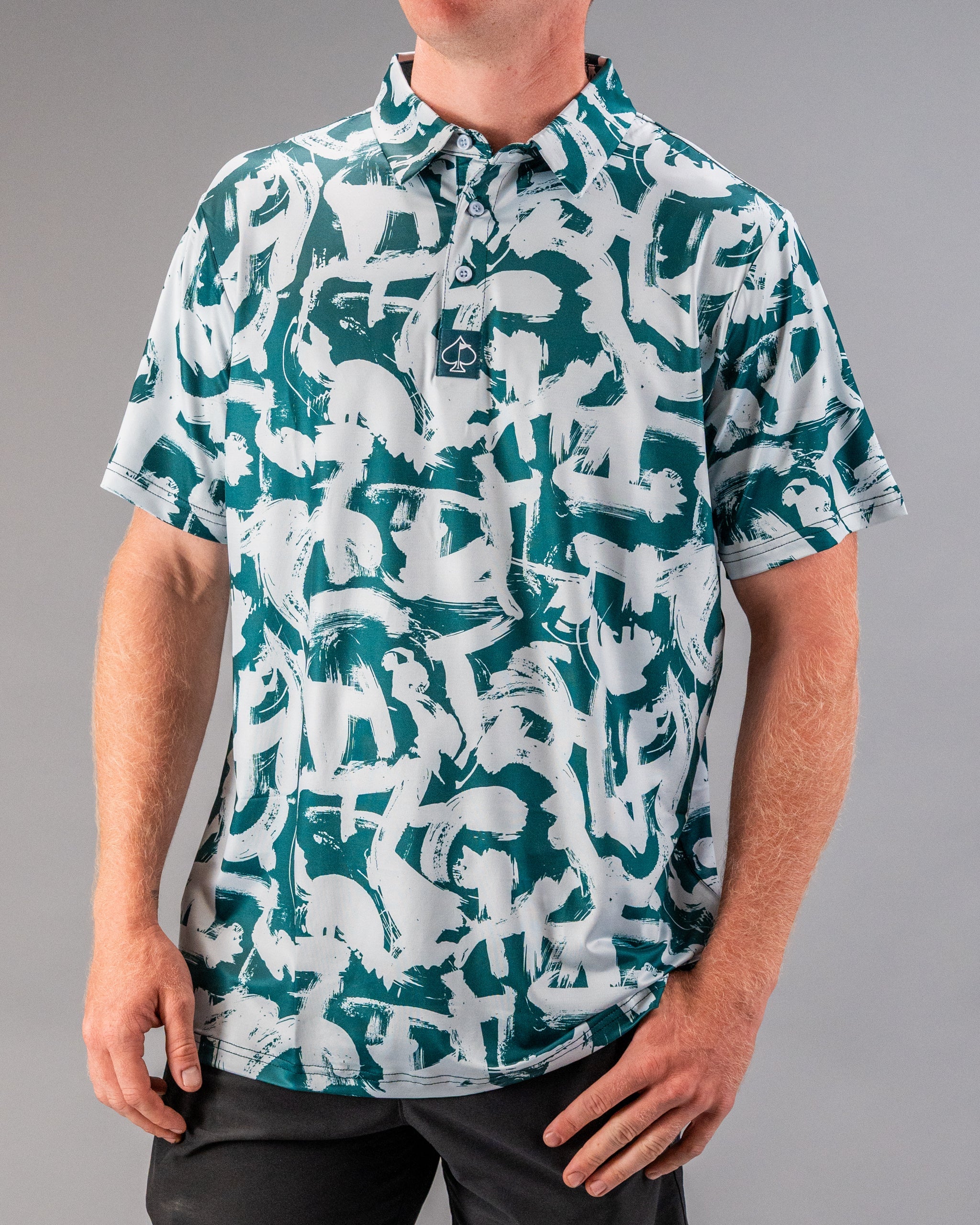 Bold green and white patterned golf polo shirt featuring a modern paint stroke design, perfect for stylish golfers.