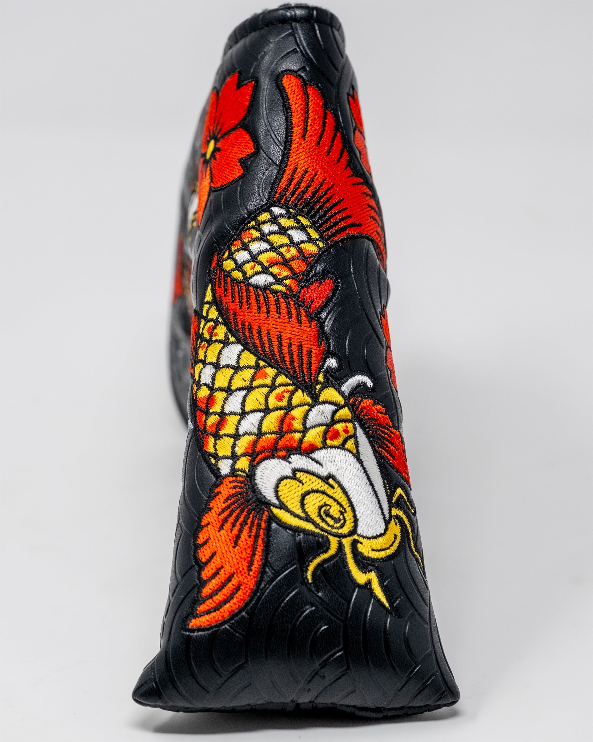 Koi Flow Blade Putter Cover featuring vibrant fire wave designs and a sleek fit for golf clubs.