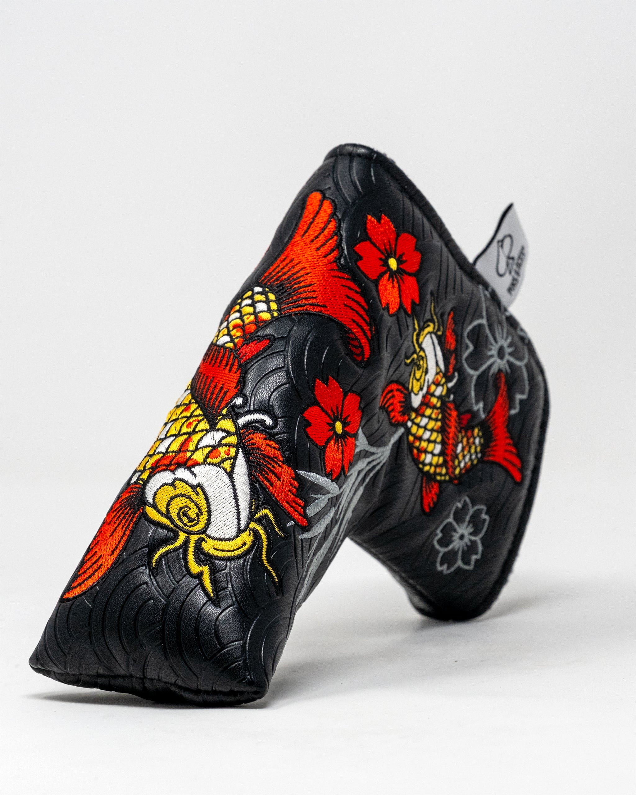 Koi Flow Blade Putter Cover featuring a vibrant fire wave design in hues of orange, red, and blue.