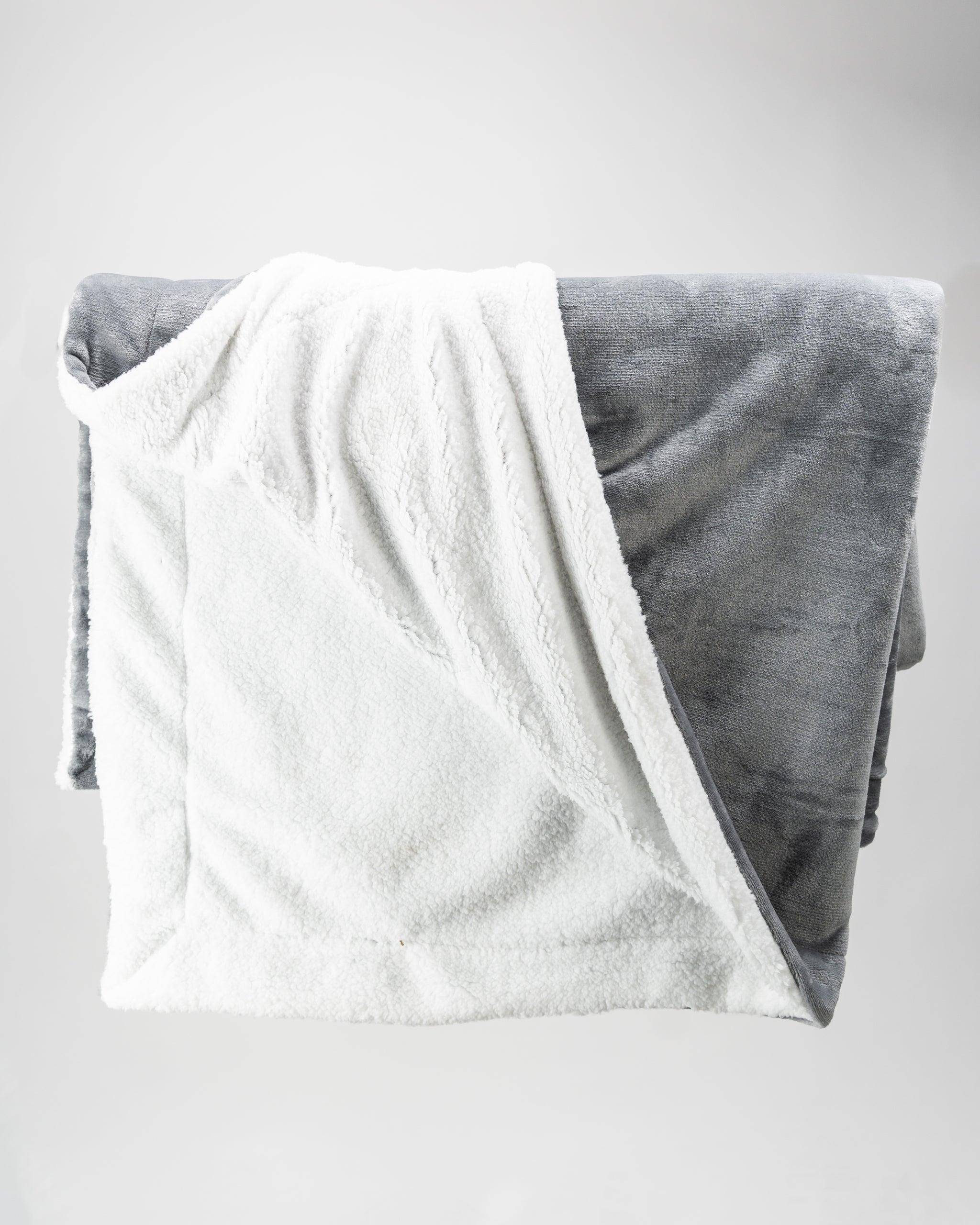 Light gray Bogey Blanket on a white background, showcasing a soft, plush texture and cozy design.