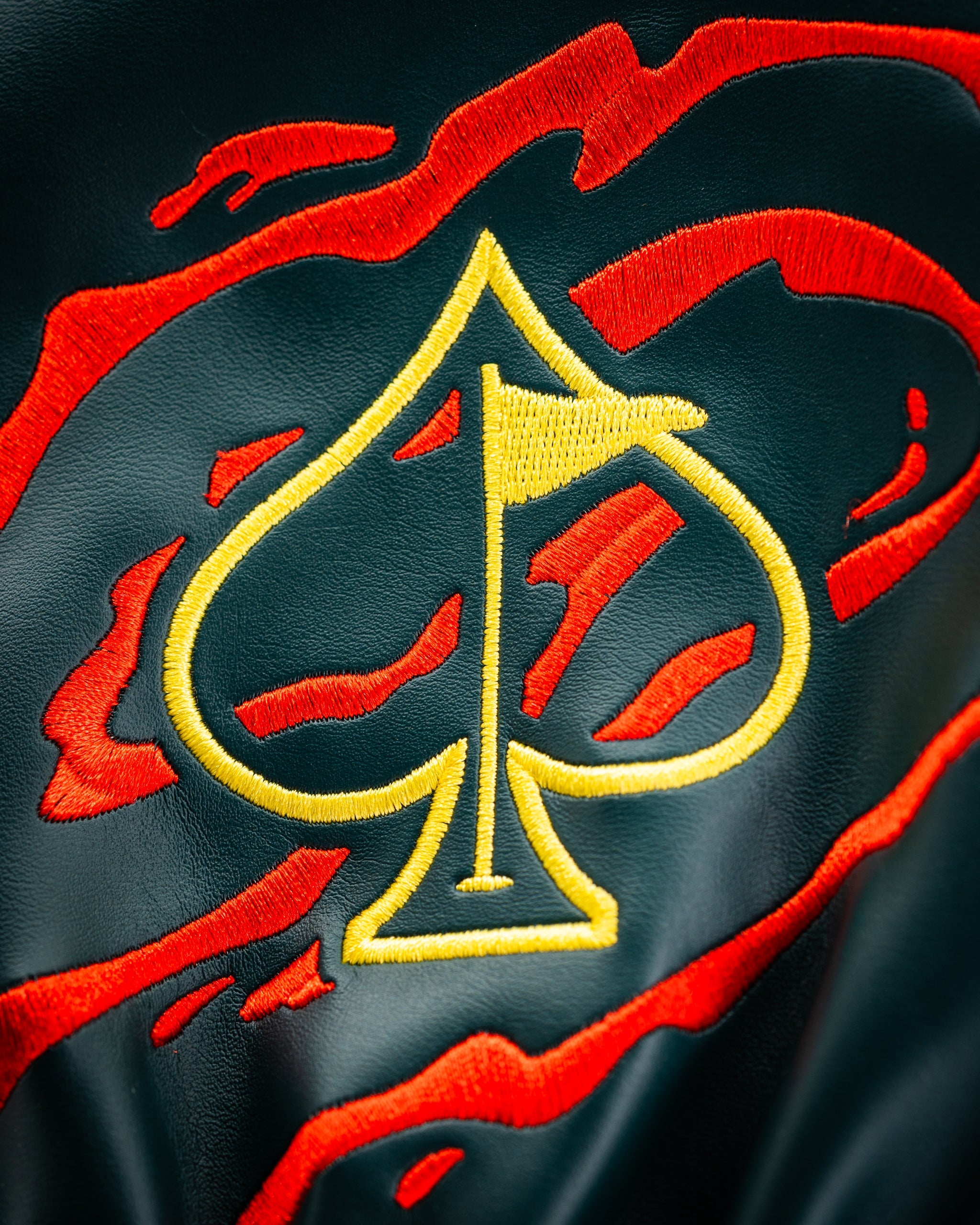 Bold driver cover featuring a vibrant red and black design with a large yellow spade emblem. Perfect for standout golfers.