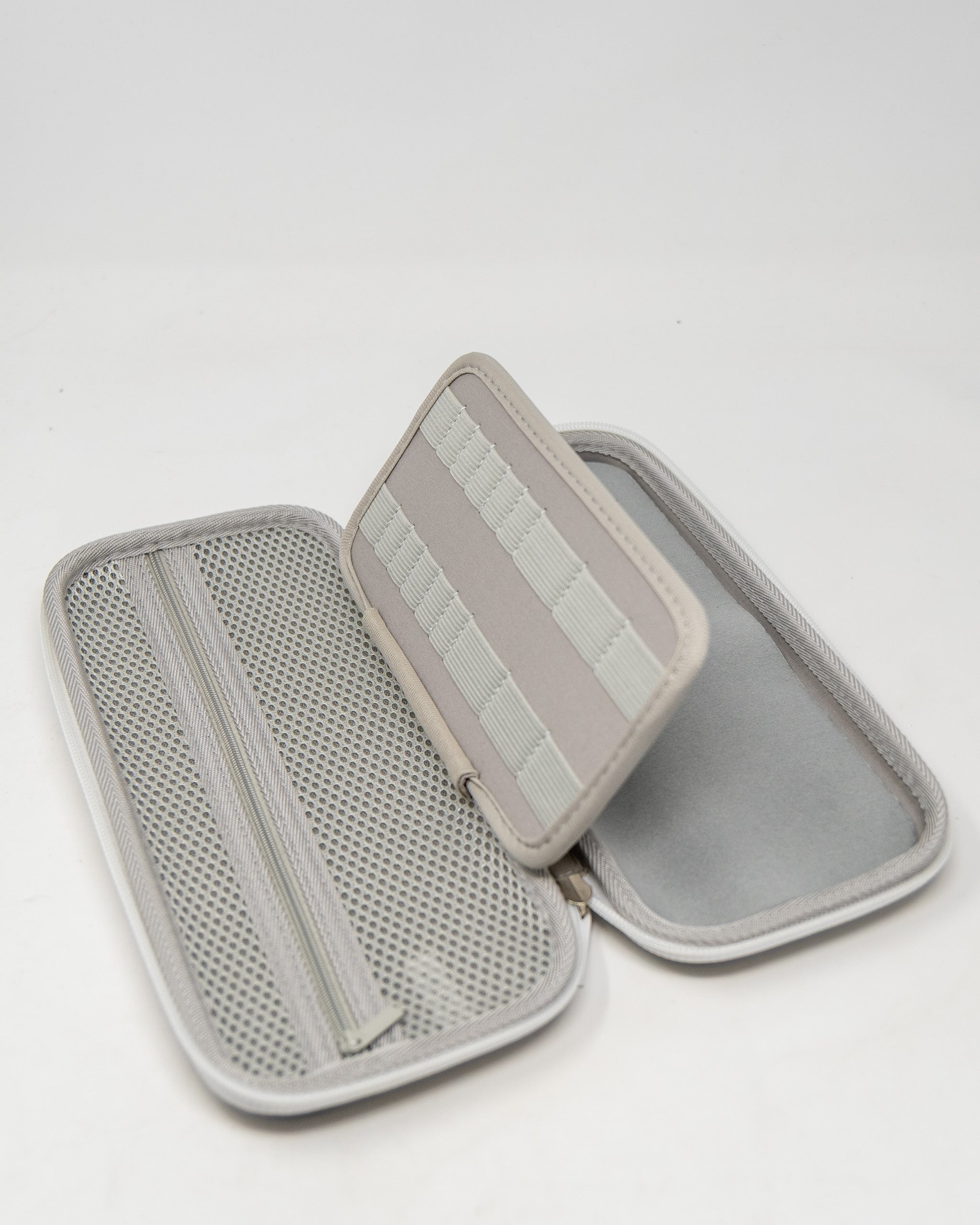 Gray glove and accessory caddie with a zippered compartment and elastic straps for organization.