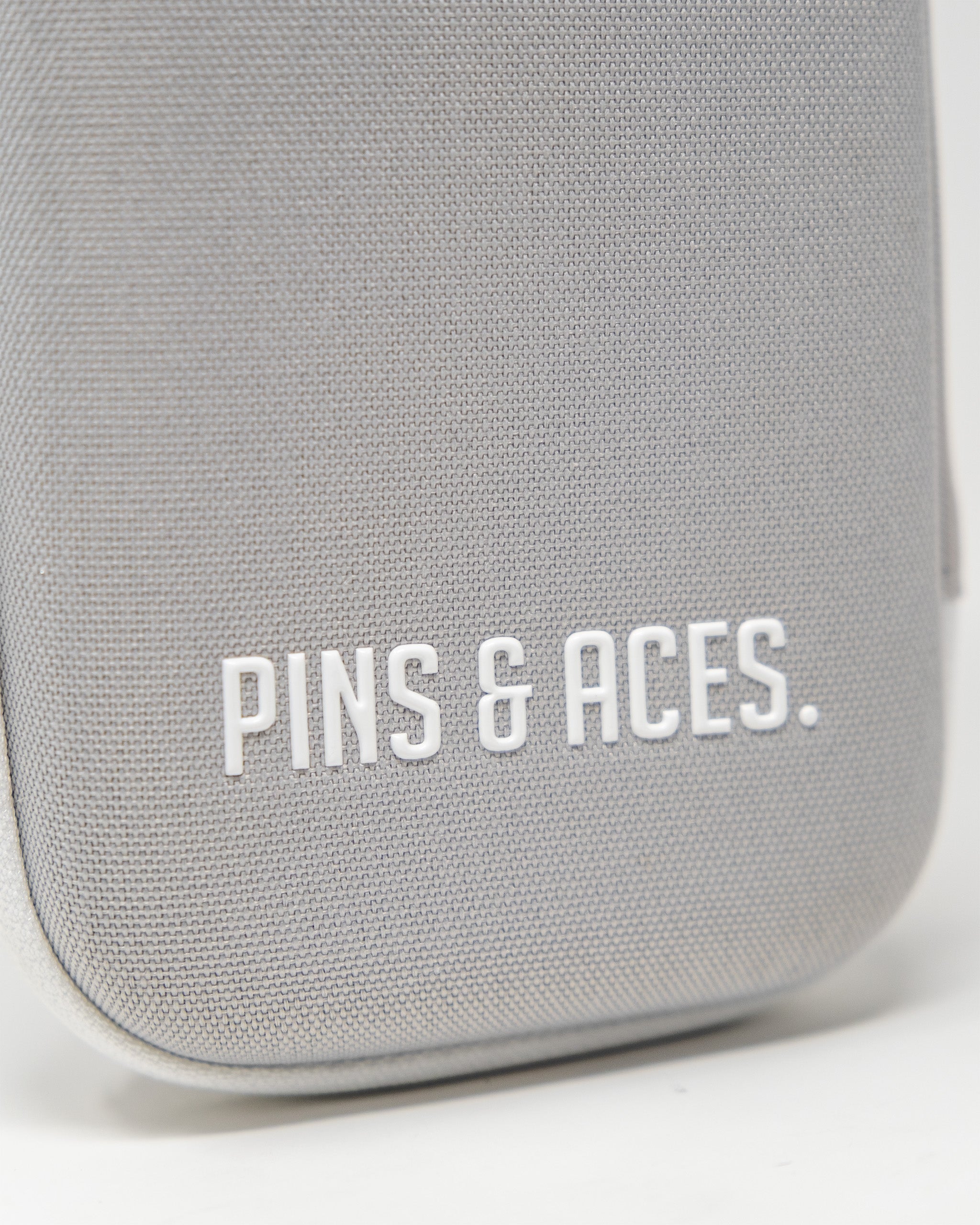 Gray glove and accessory caddie featuring the Pins & Aces logo, designed for organized storage and easy access.