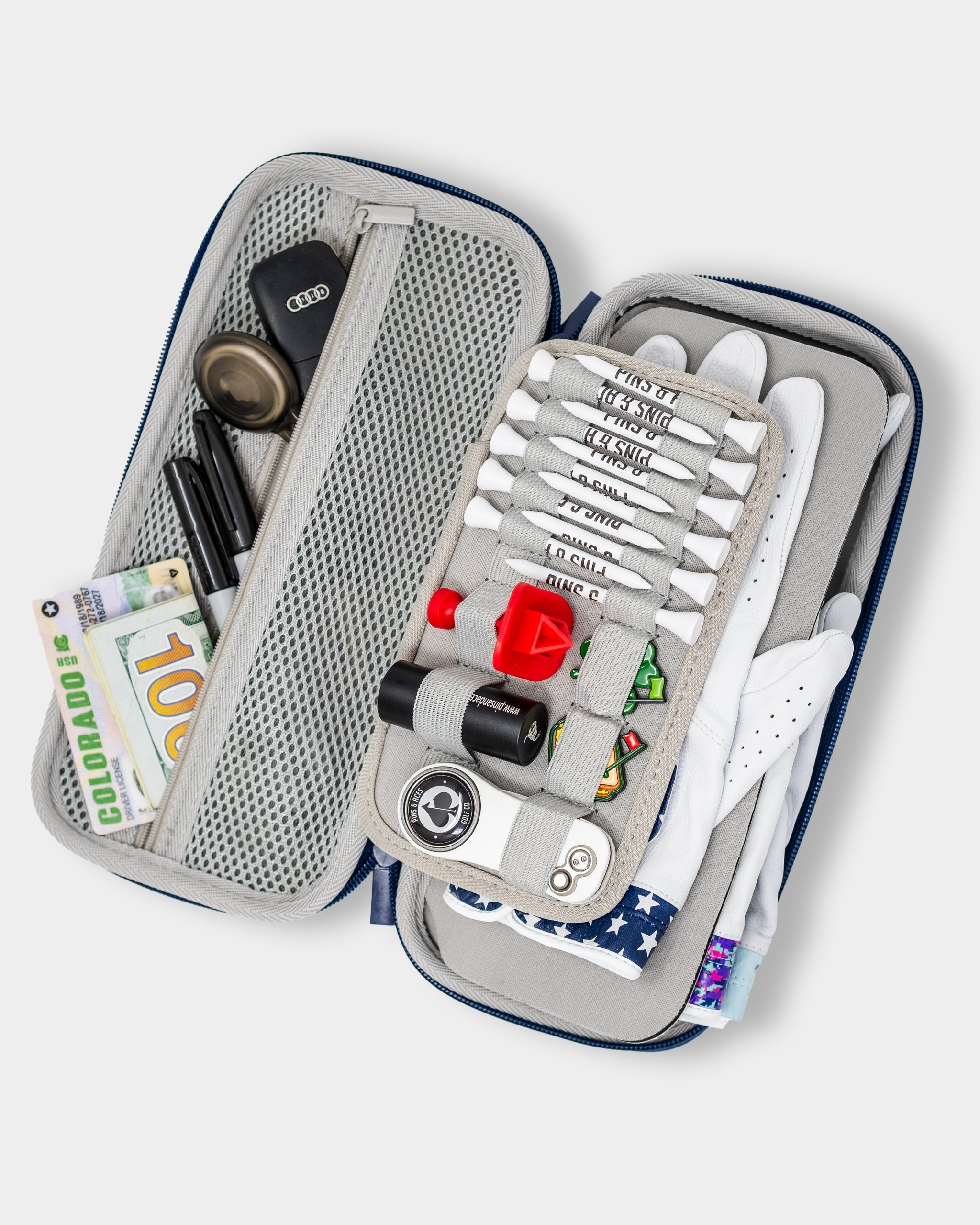 Navy glove and accessory caddie with open compartments, featuring various golf accessories.