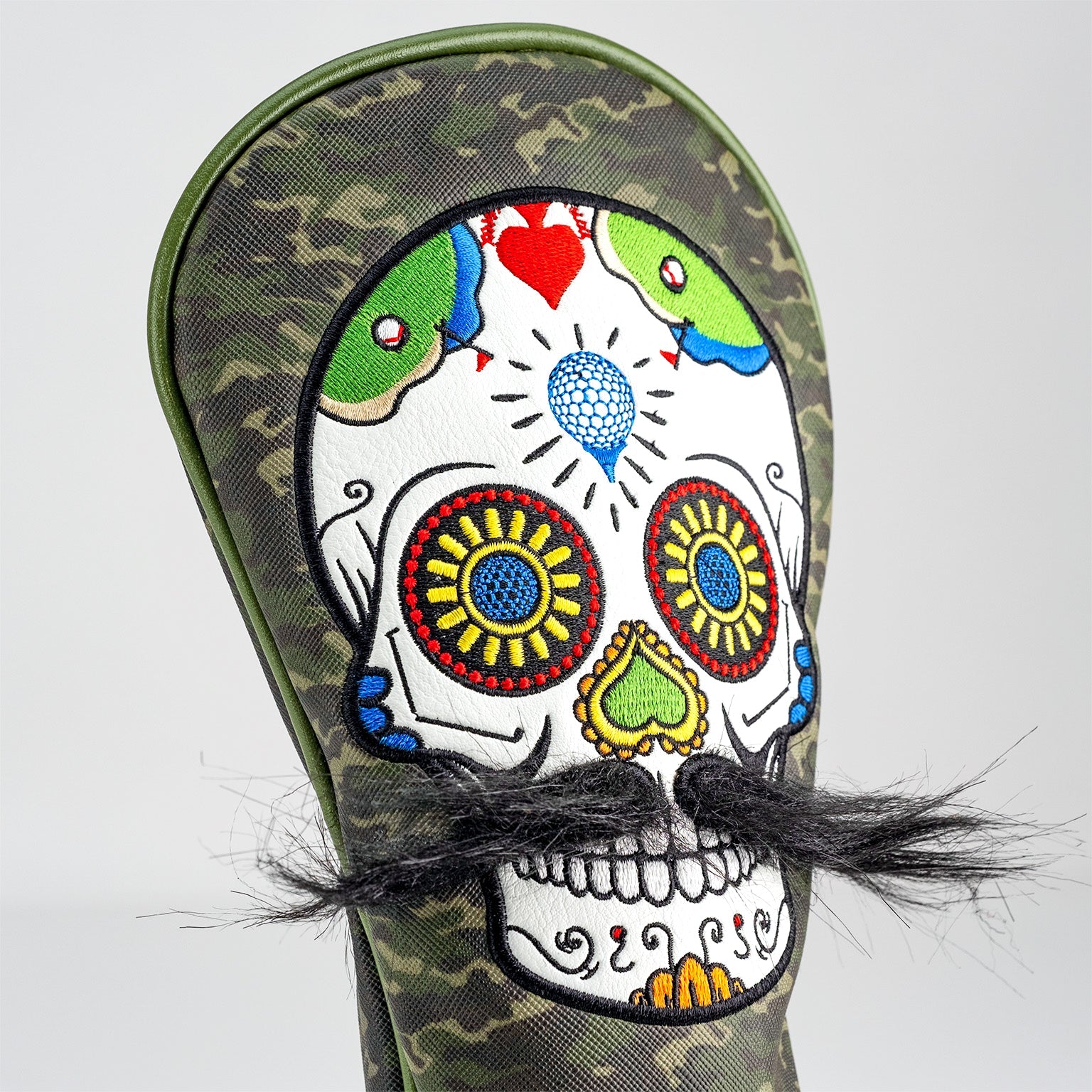 Green camo mustache sugar skull driver cover, featuring intricate details and a stylish design for golf enthusiasts.