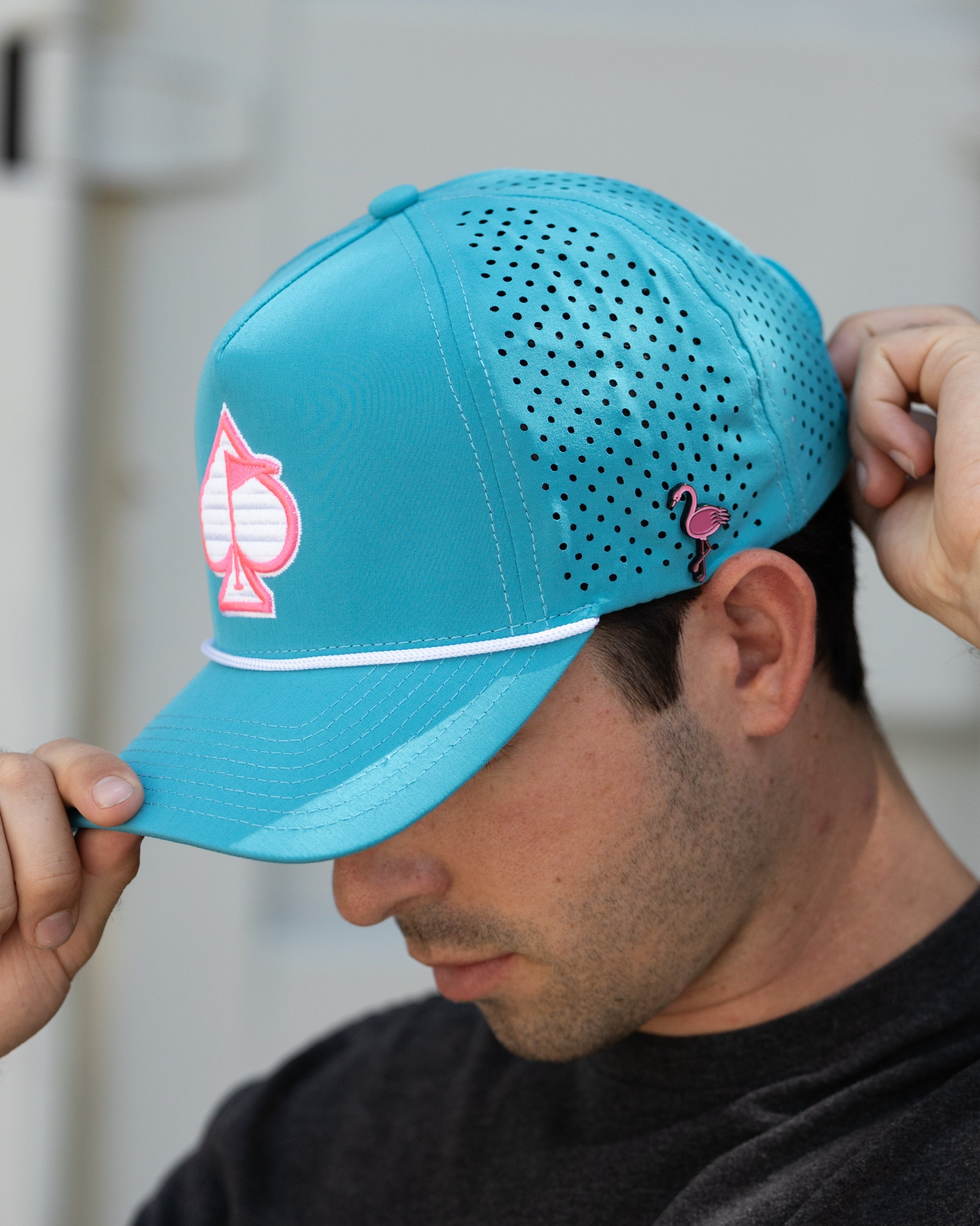 Perforated baby blue rope hat with a stylish design, set against a vibrant background.