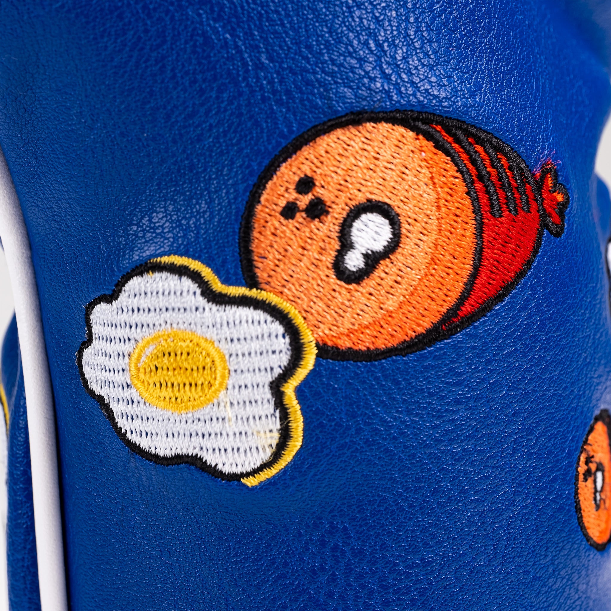 Close-up of Ham & Eggs Fairway Cover featuring vibrant colors and golf-themed design.