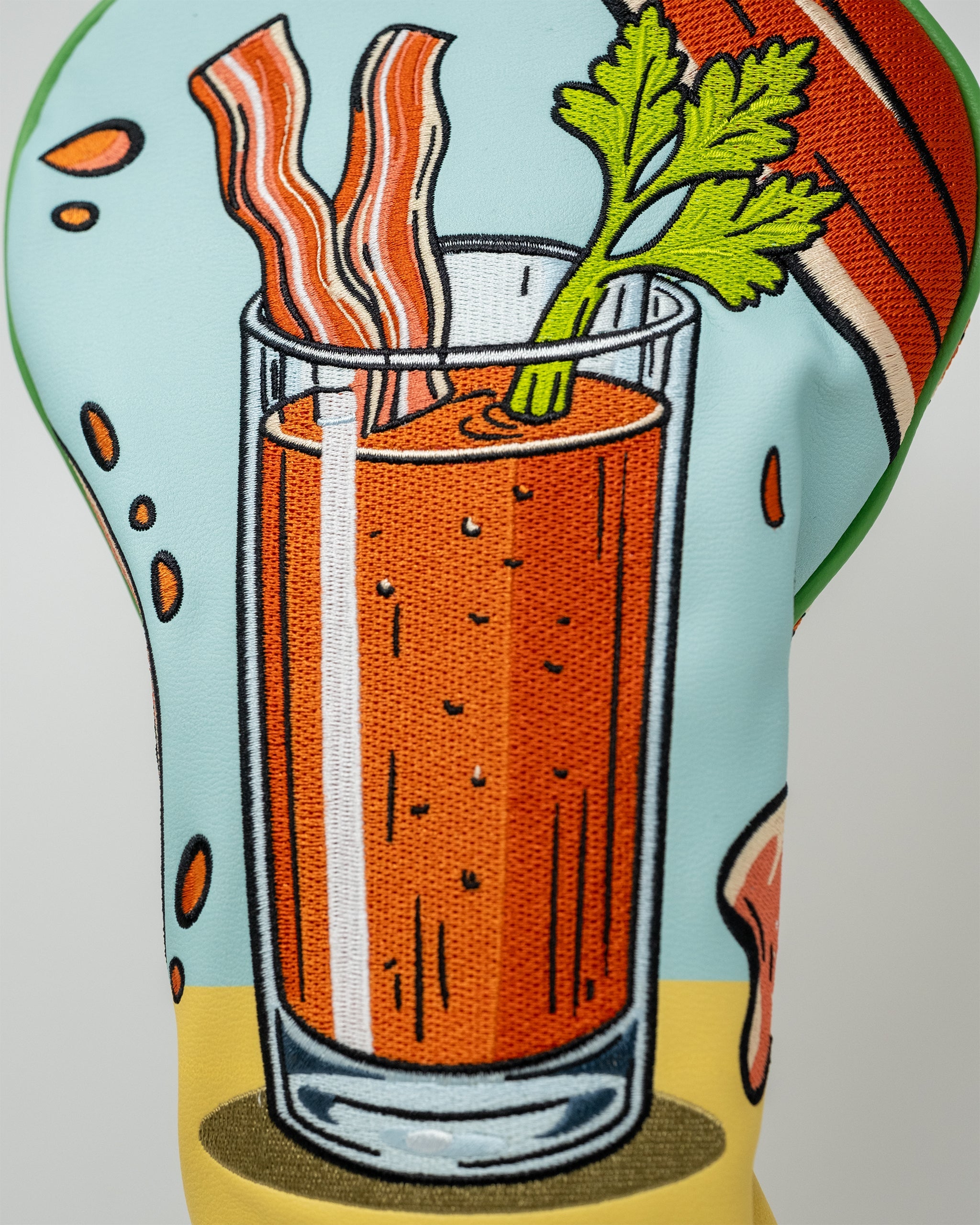 Bloody Mary driver cover featuring a whimsical red and green design with a playful tomato and garnish accents.