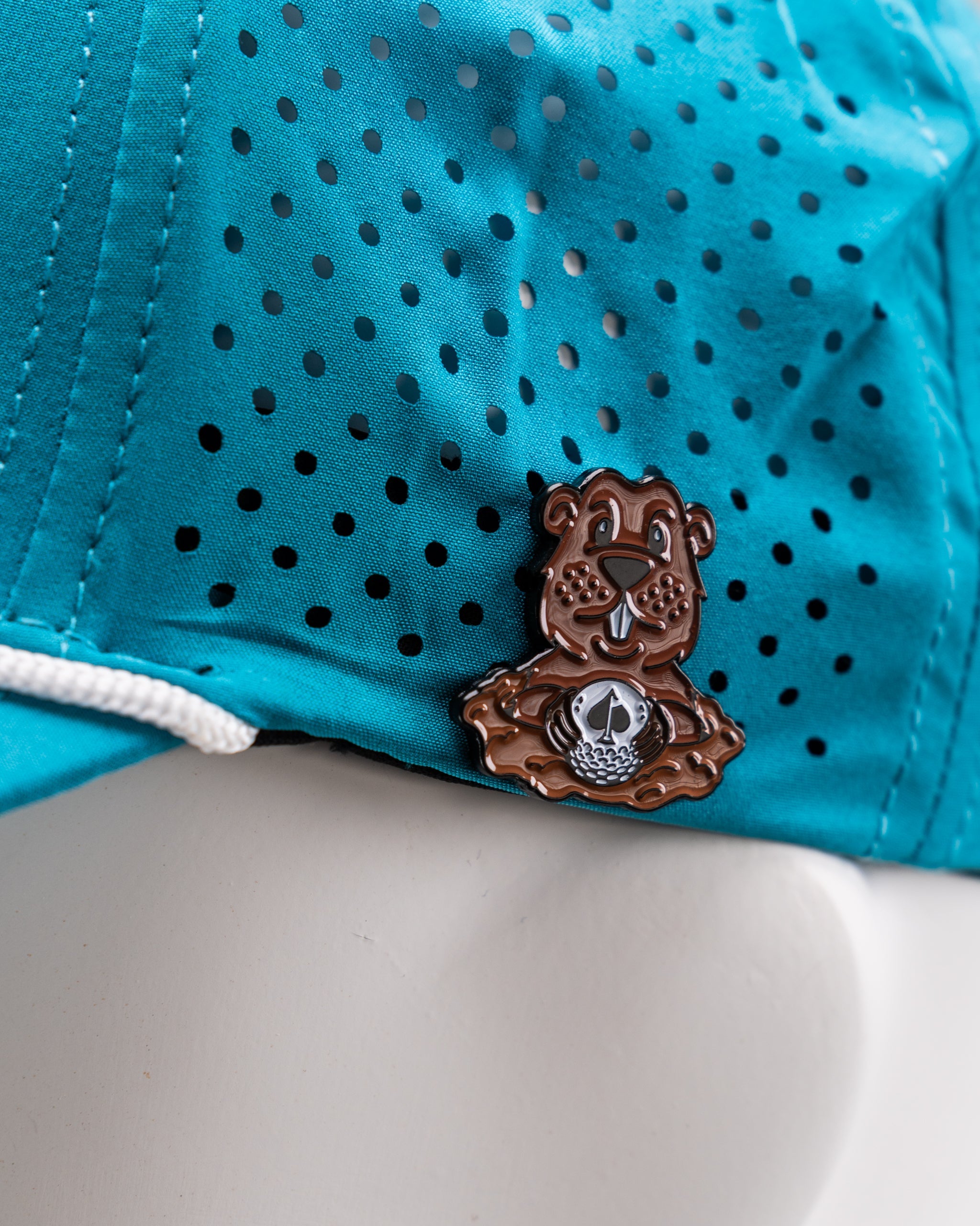 Perforated baby blue rope hat featuring a Beaver Liquor logo patch.