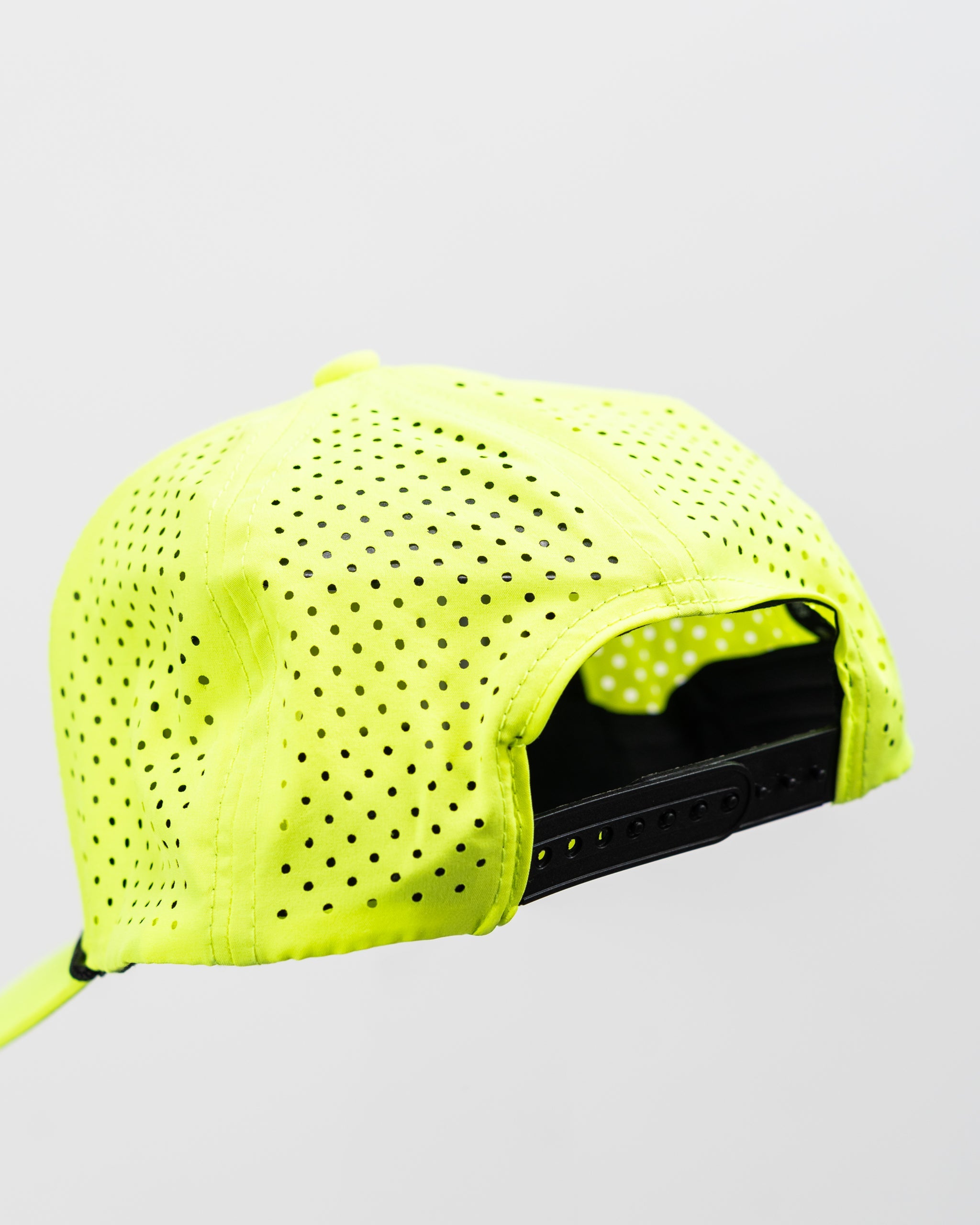 Highlighter yellow perforated rope hat with snapback closure.