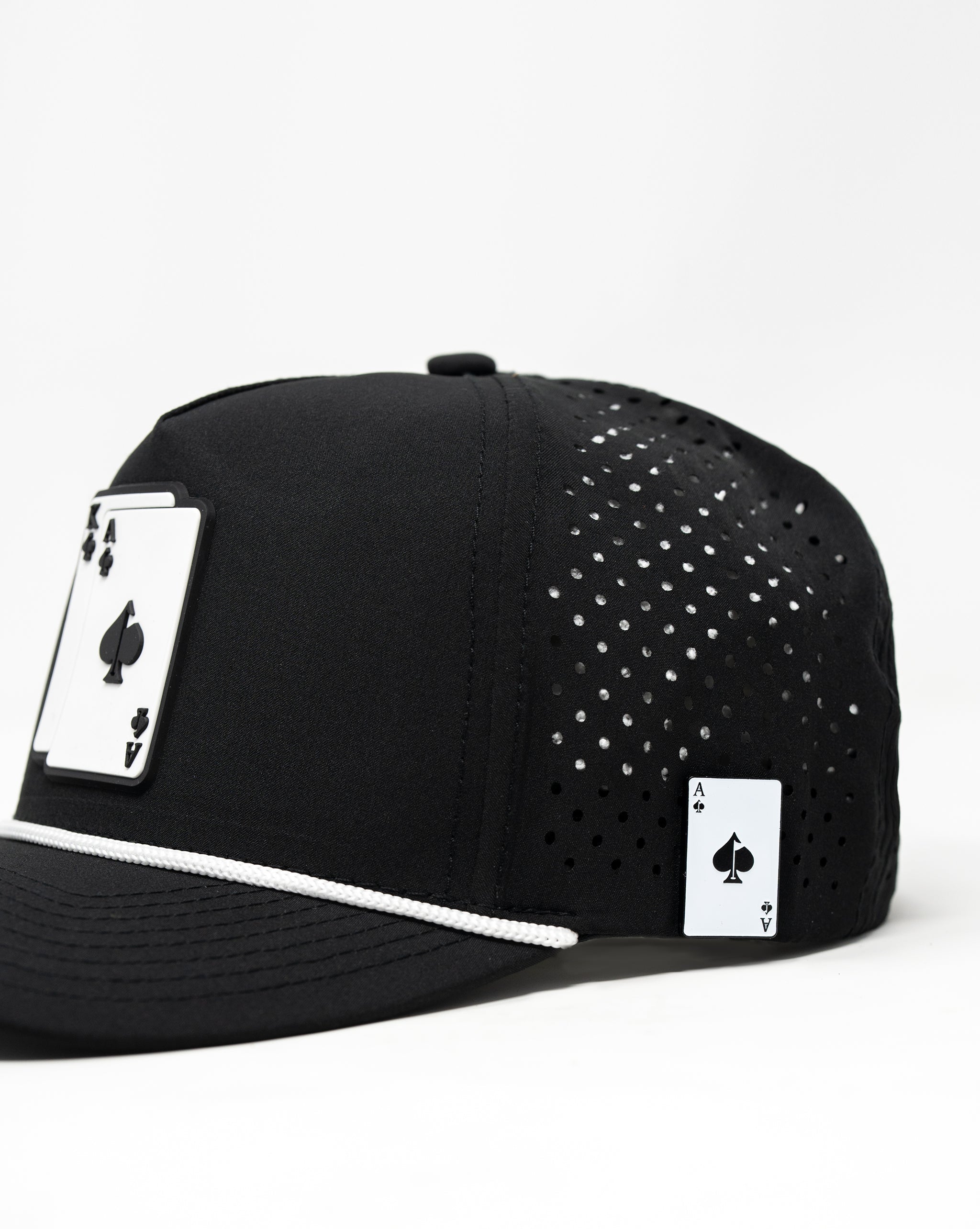 Perforated black rope hat with embroidered AK logo and adjustable strap.