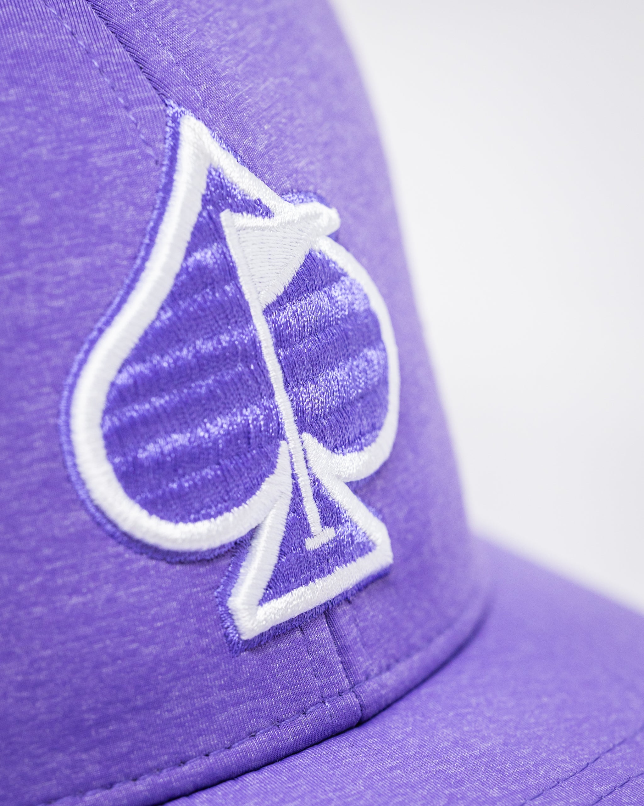 Performance Spade Hat in Lavender, showcasing a stylish design with a curved brim and adjustable strap, set against a neutral background.