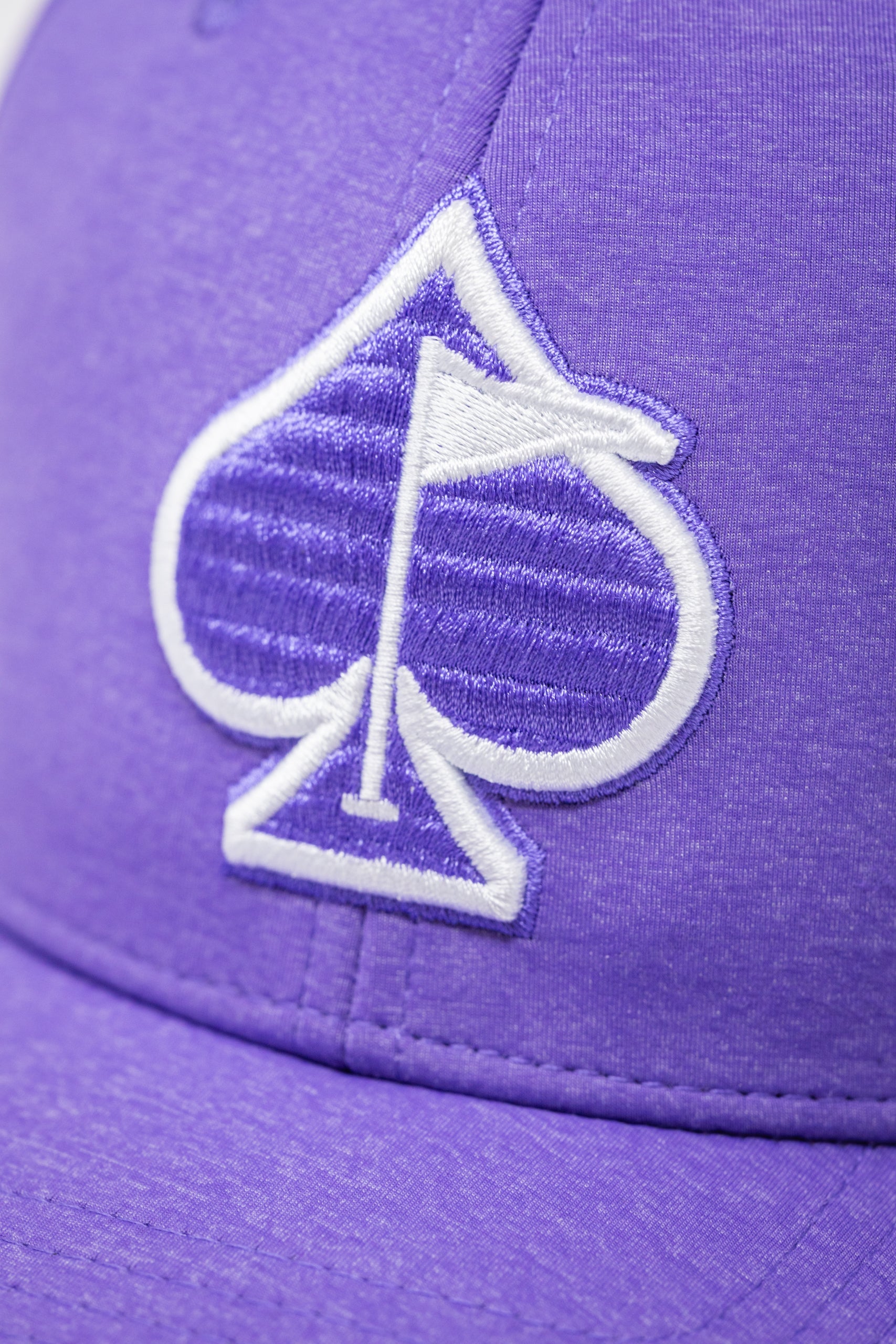 Lavender Performance Spade Hat with a logo and adjustable strap.