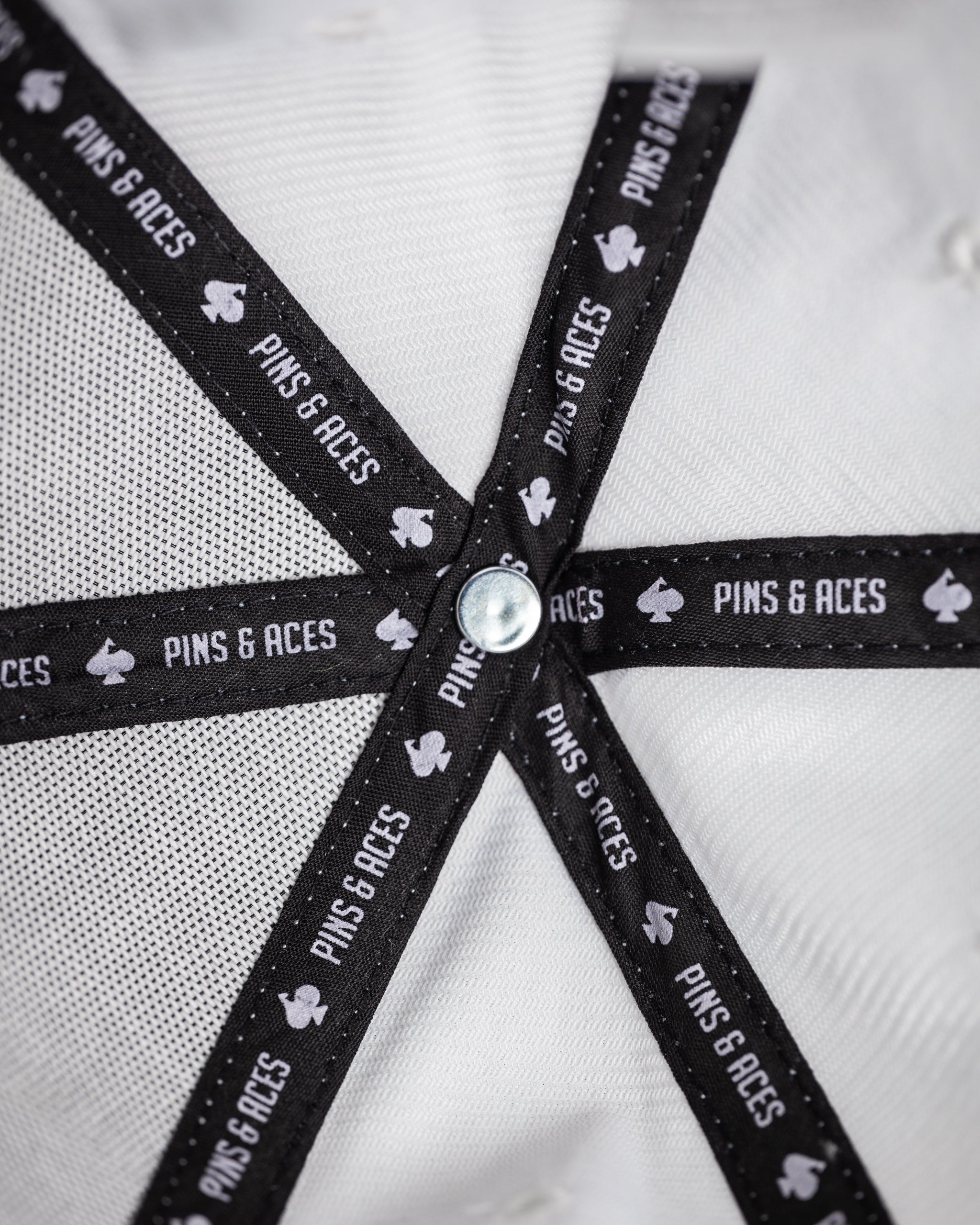 Performance Spade Hat in White, featuring a sleek design and breathable fabric, perfect for outdoor activities.