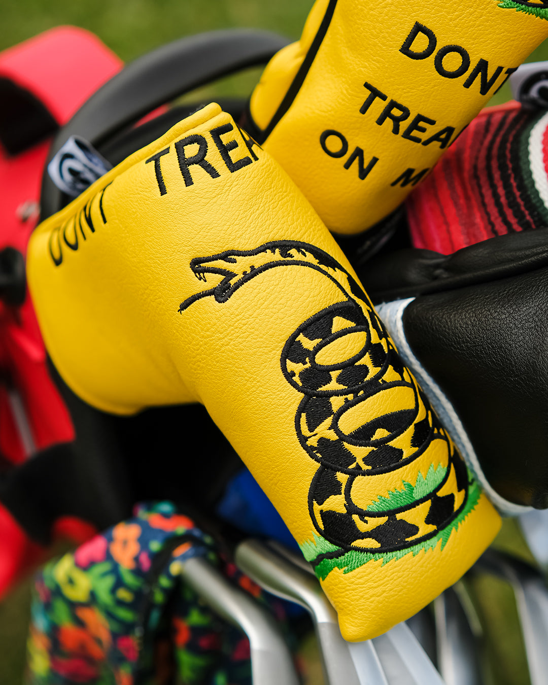 "Don't Tread on Me blade putter cover with a patriotic yellow and black design featuring a coiled snake."