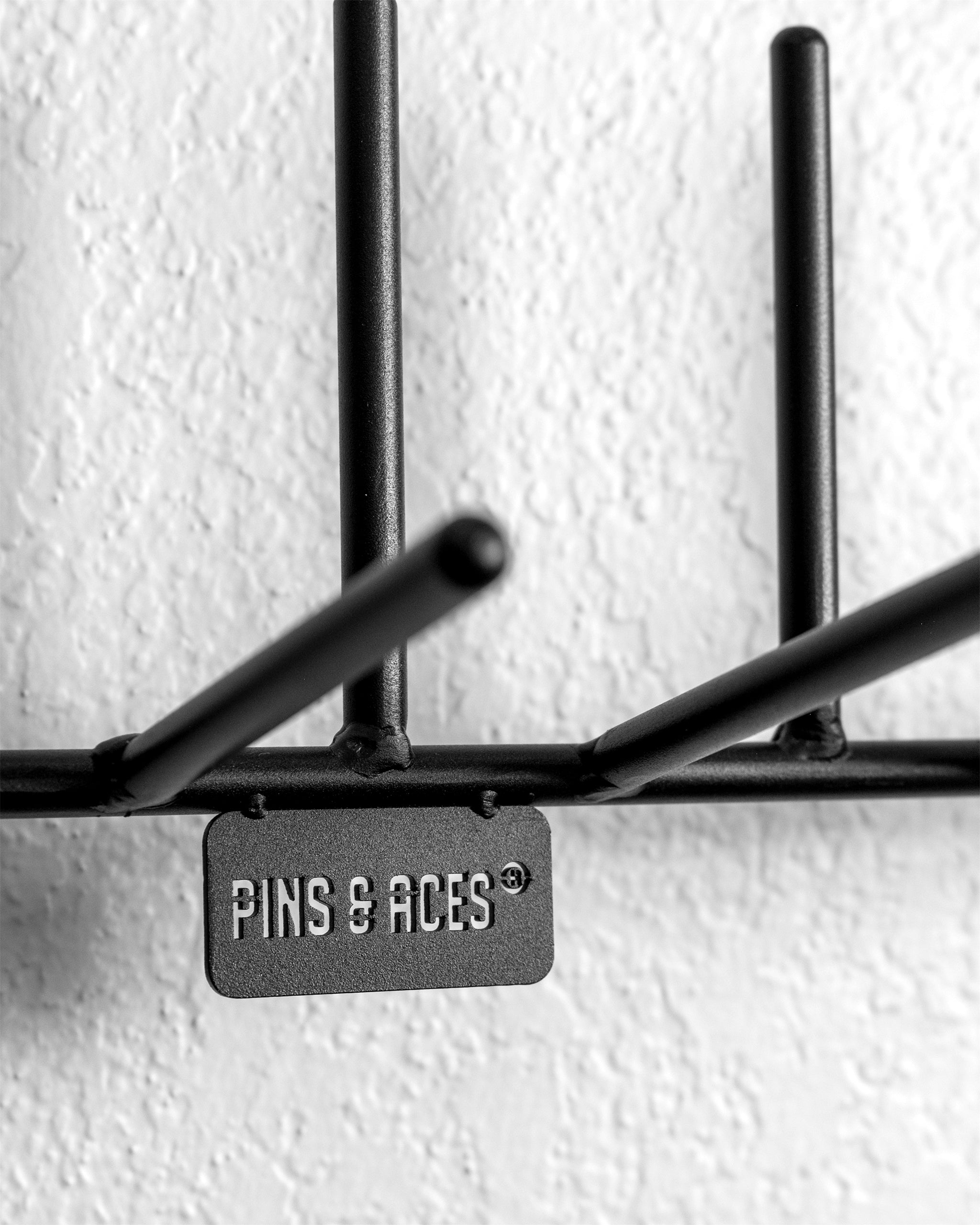 Headcover rack displaying multiple golf headcovers organized neatly on a sleek, modern stand.