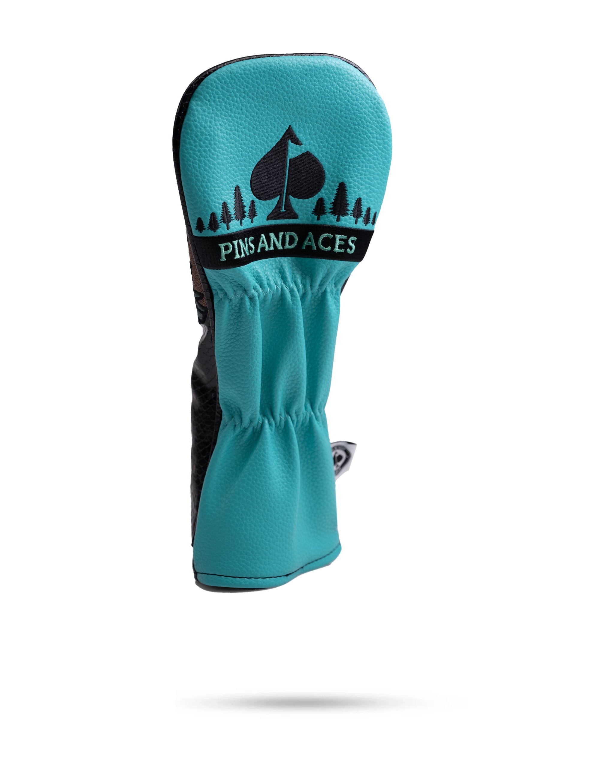 Bright turquoise golf club headcover with "PINS AND ACES" logo and spade symbol, designed for golfers who stand out.